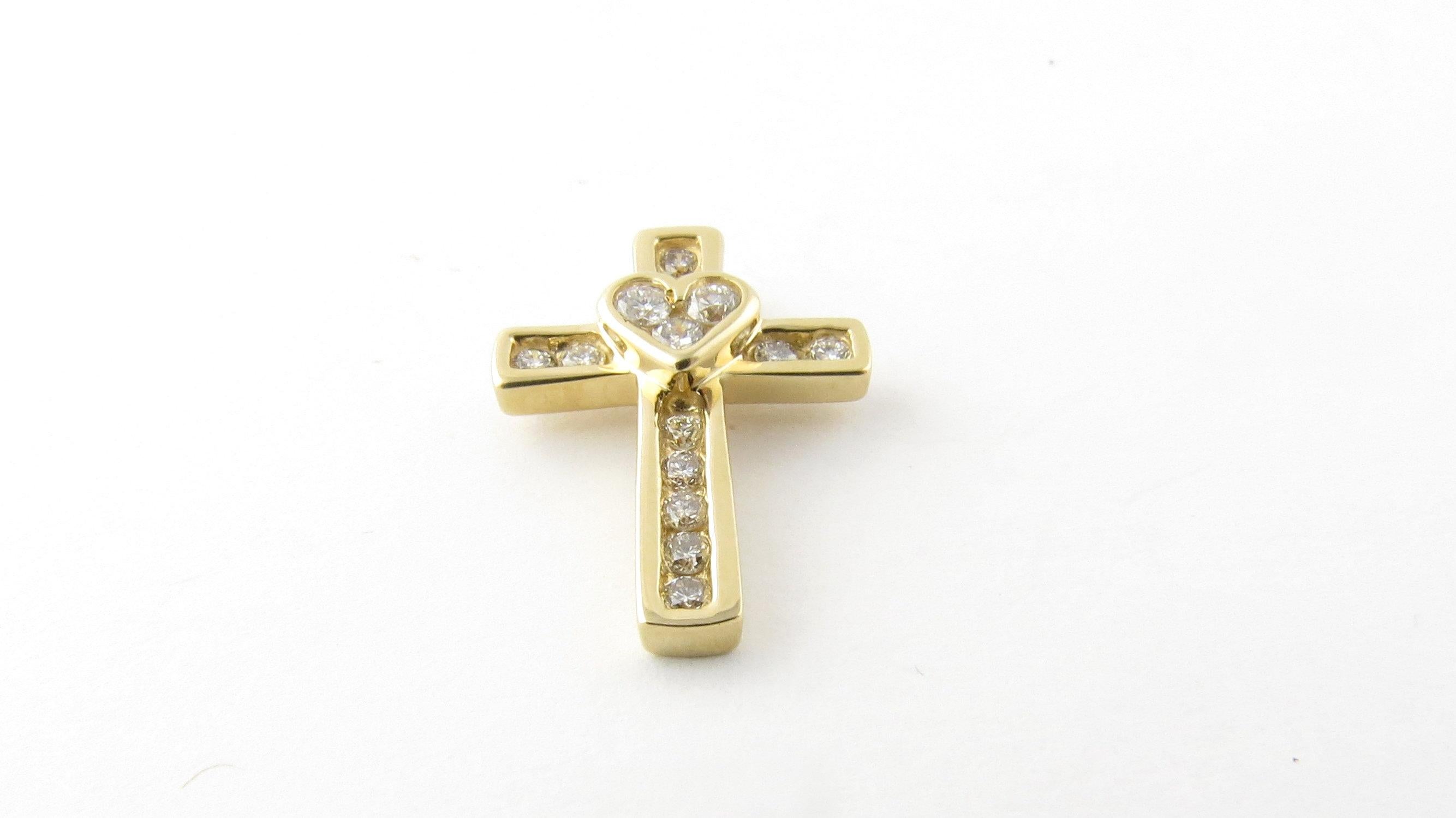 Vintage 14 Karat Yellow Gold Diamond Cross Pendant
This sparkling cross pendant with a lovely heart in its center is decorated with 14 round brilliant cut diamonds set in 14K yellow gold. 
Approximate total diamond weight: .30 ct. 
Diamond color: