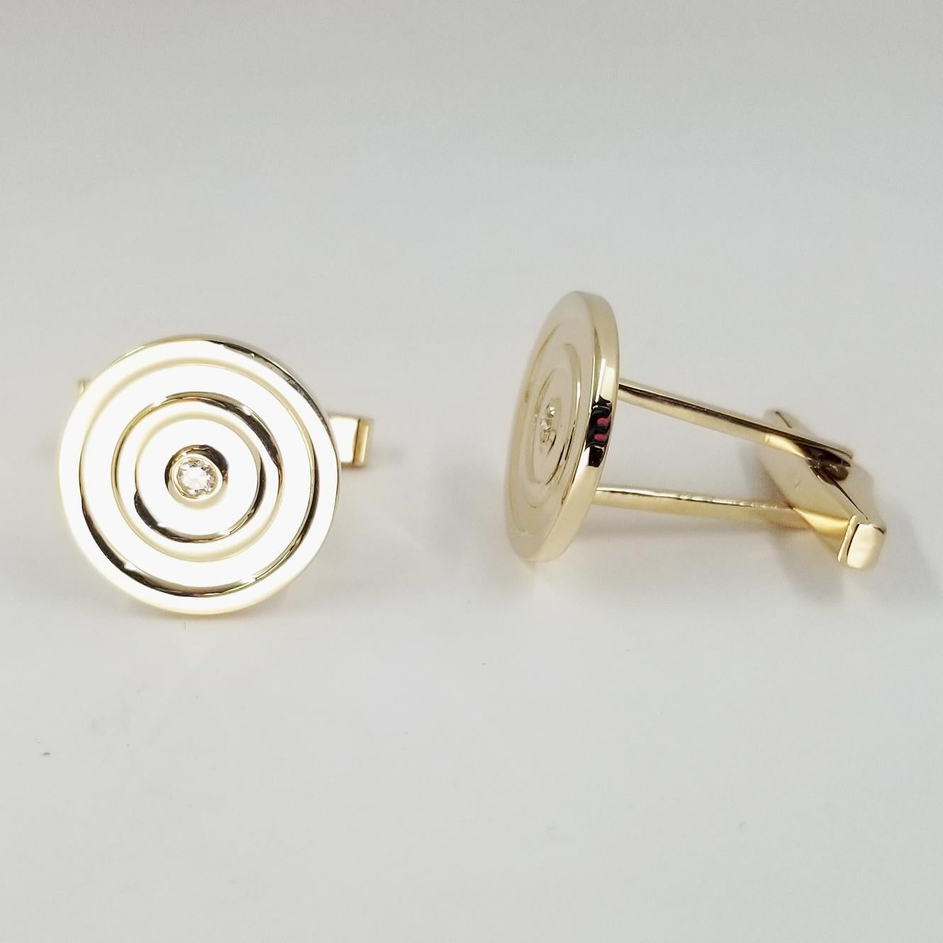 14 Karat Yellow Gold Ringed Cufflinks Featuring 2 Round Bezel Set Diamonds Totaling Approx 0.10 Carat. Finished Weight is 11.8 grams. Torpedo Backs.