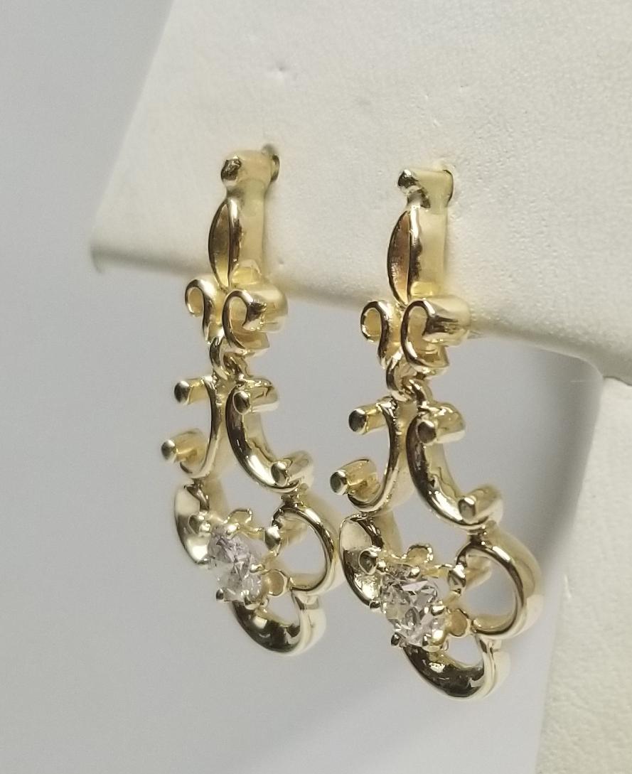 boucles d'oreilles pendantes en or jaune 14 carats, contenant 2 diamants ronds de taille brillant de très belle qualité pesant .66pts.