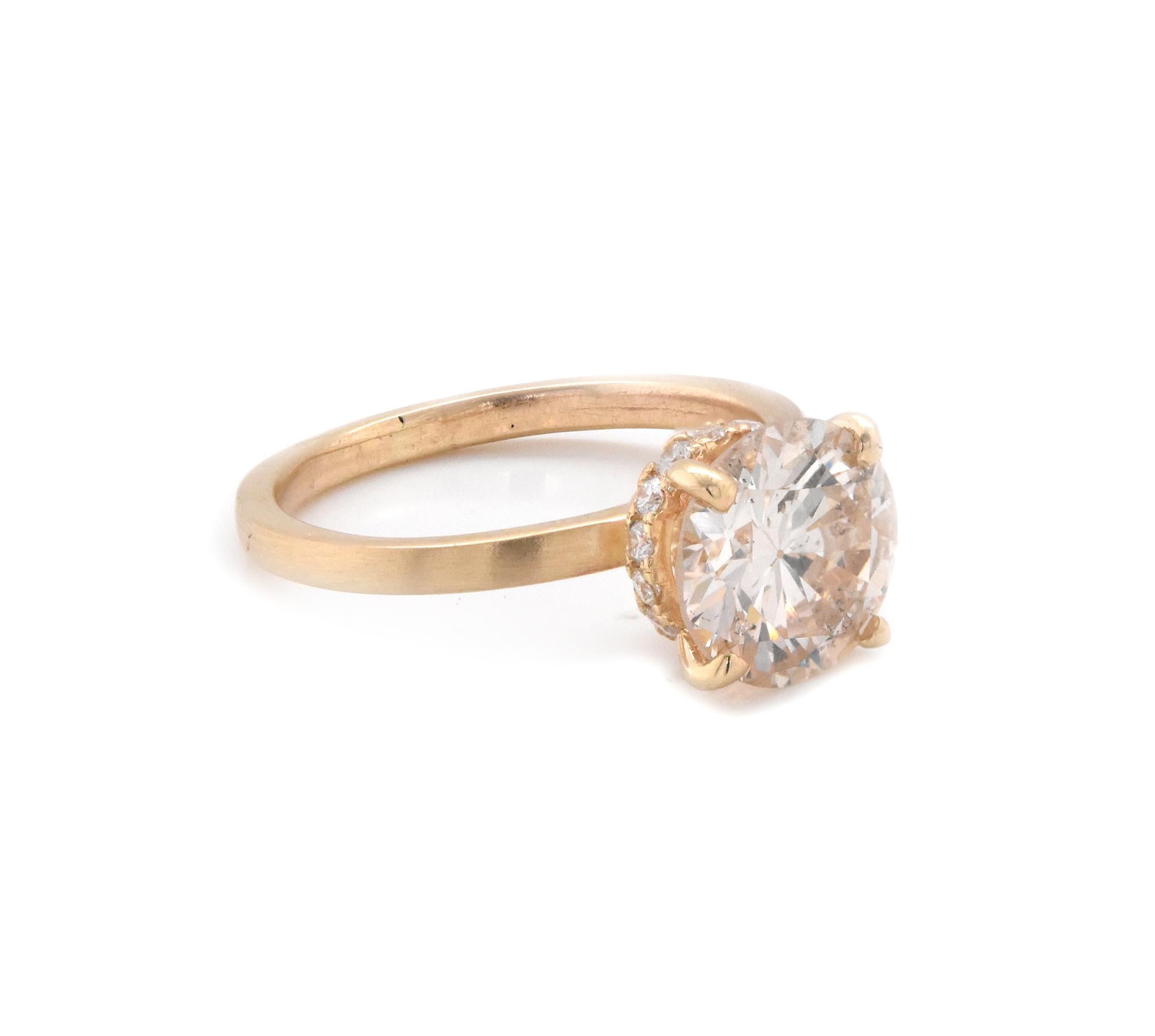 Material: 14K yellow gold
Center Diamond: 1 round brilliant cut = 2.20ct
Color: L
Clarity: I1
Diamond: 12 round cut = .25cttw
Color: G
Clarity: VS
Ring Size: 5.5 (please allow up to 2 additional business days for sizing requests)
Dimensions: ring