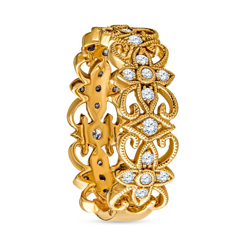 A beautiful and unique 14 karat yellow gold band featuring floral motifs, milgrain detailing, and 0.29 carat total weight in round brilliant diamonds. This ring is a size 6 but can be resized upon request. 
Measurements: Width approximately 6mm