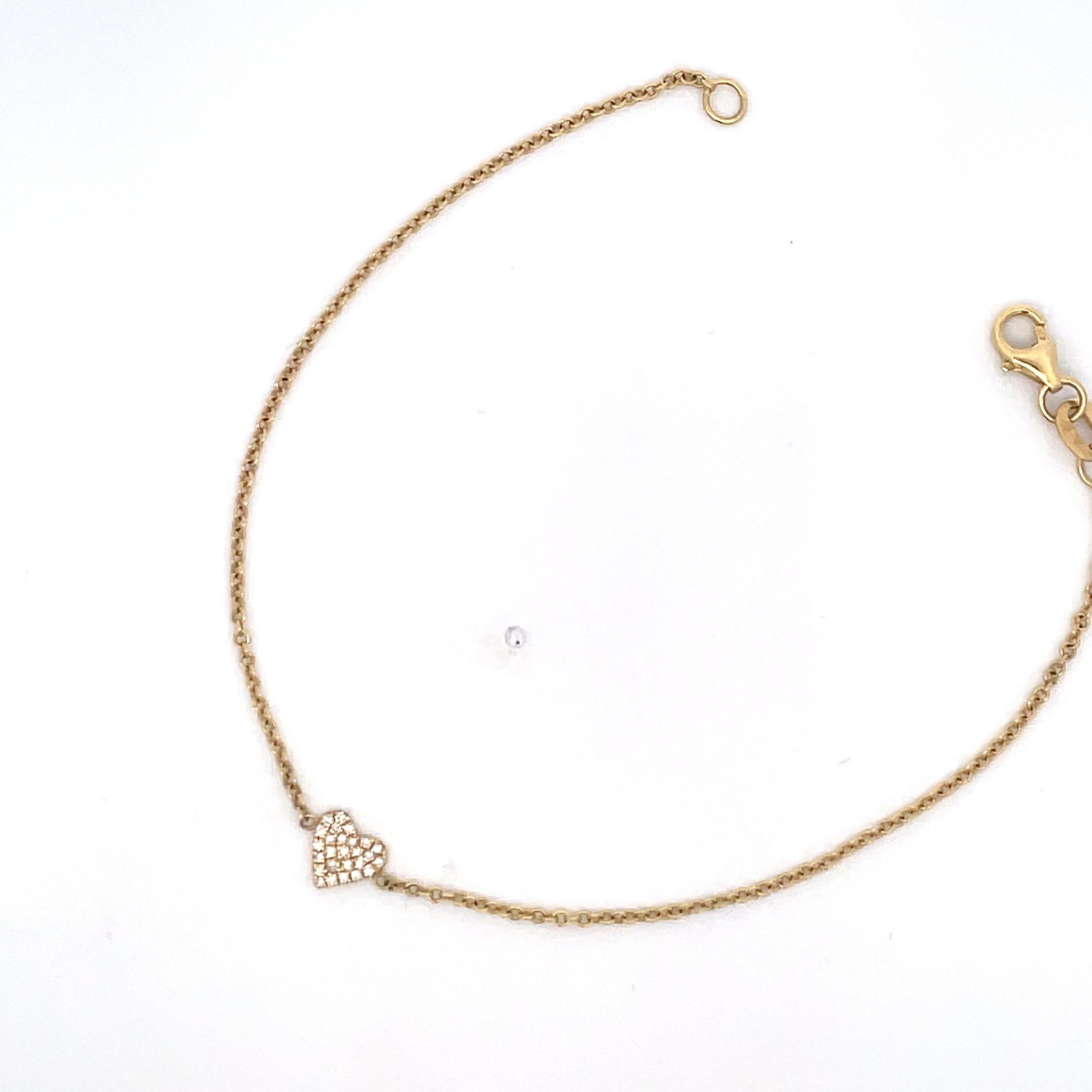 Dainty 14 Karat Yellow gold bracelet featuring a small diamond heart weighing 0.20 carats. 
Great to stack or wear alone. 
