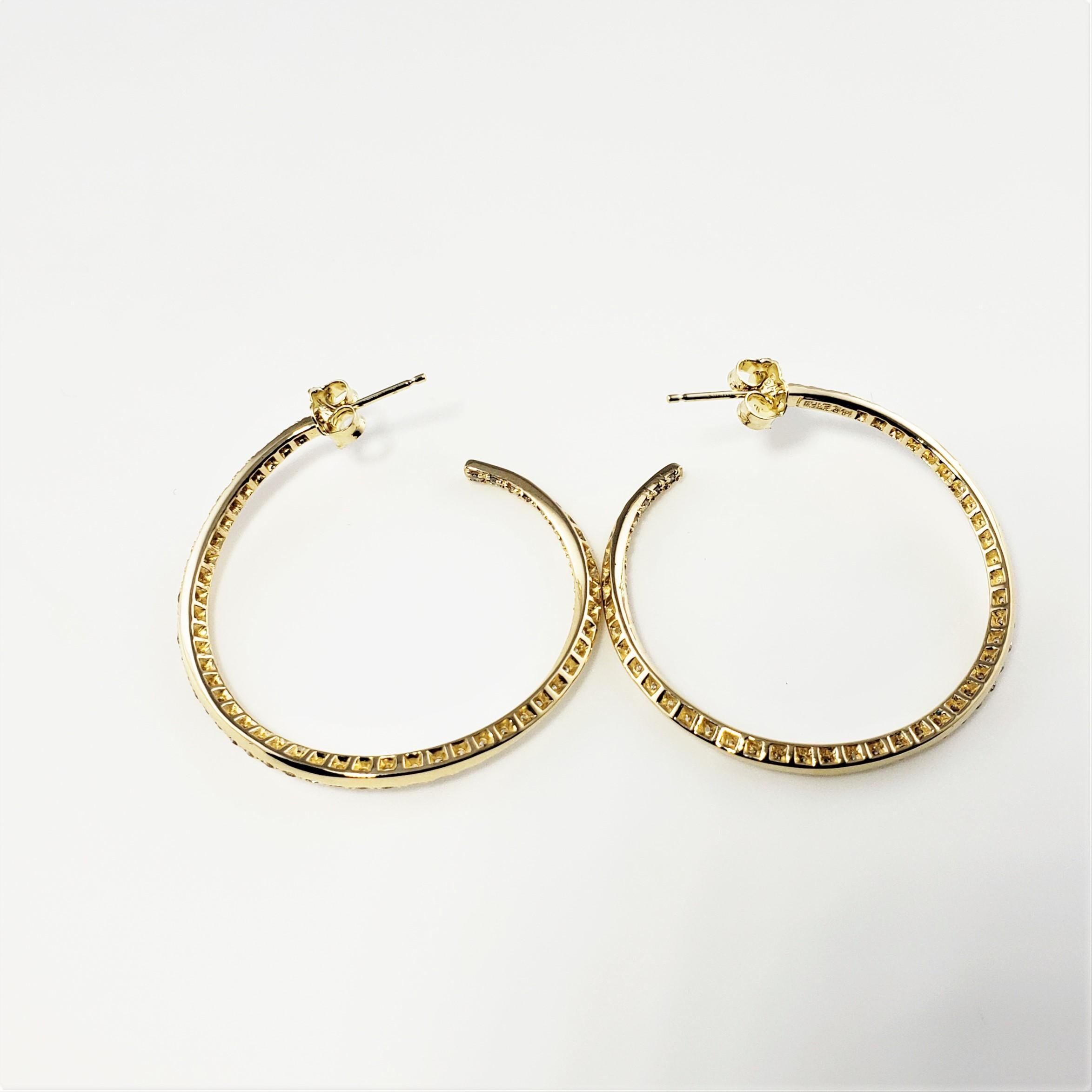 14 Karat Yellow Gold Diamond Hoop Earrings-

These sparkling hoop earrings each feature 49 round brilliant cut diamonds set in beautifully detailed 14K yellow gold.

Approximate total diamond weight:  .98 ct.

Diamond color:  G-H

Diamond clarity: 