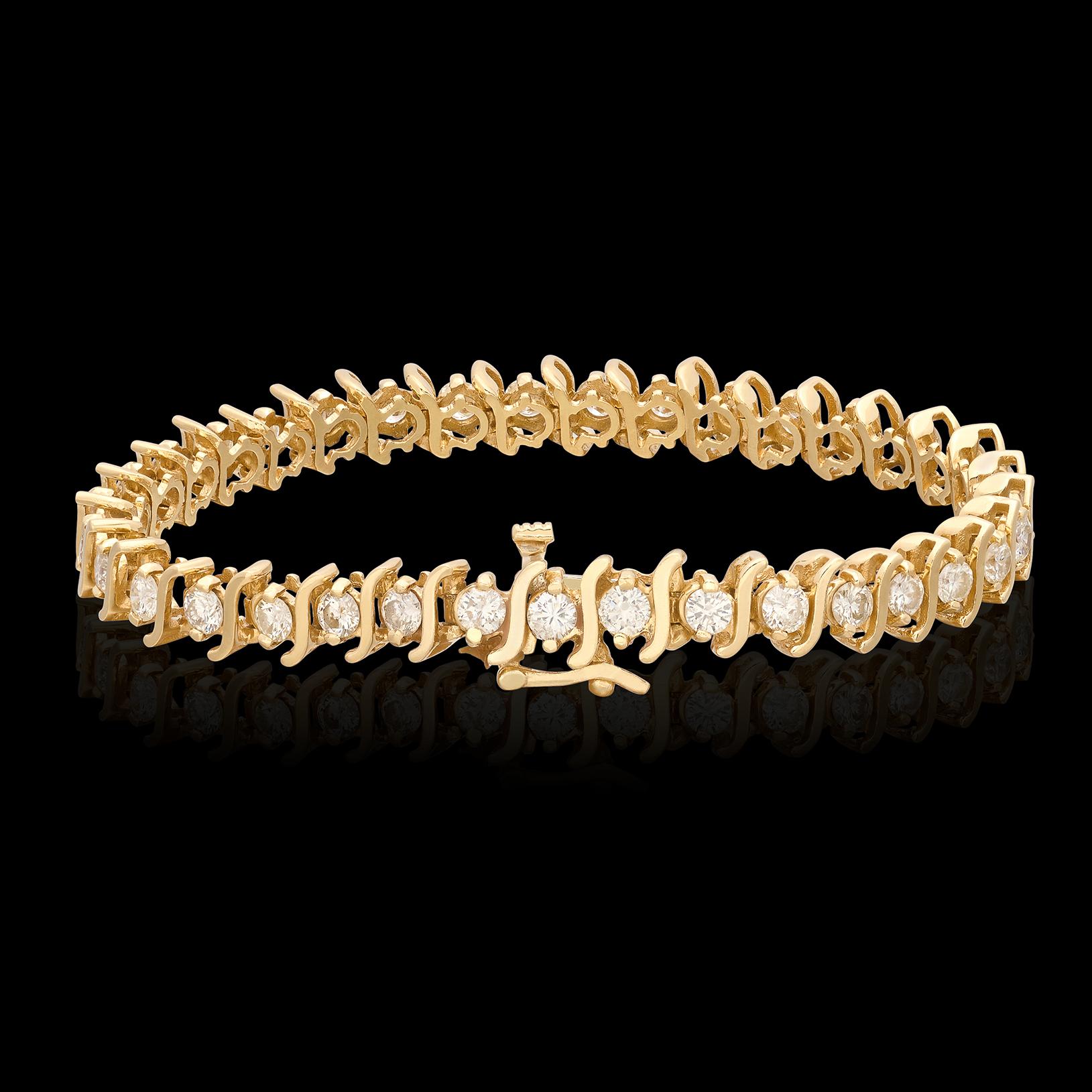 As stylish now as it was in the 1970's when this design first appeared. This yellow gold diamond tennis bracelet features 35 incredibly well-matched fine white diamonds for 3.85 carats total weight. The diamonds average G color and VS clarity, and