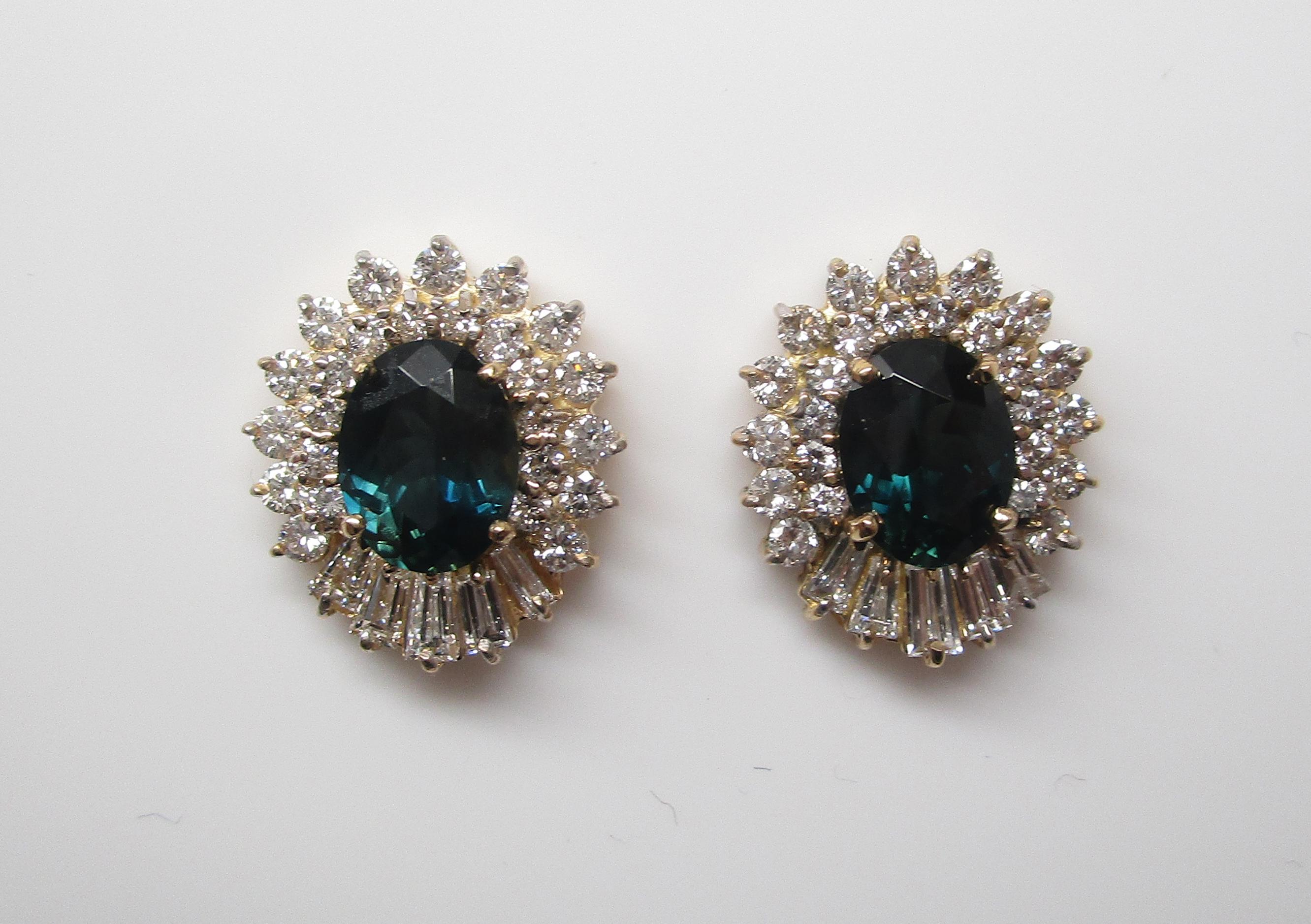 These amazing midcentury earrings are in 14k yellow gold and have diamond frames surrounding some of the most remarkable colored stones you’ll ever see - natural color-change sapphires! These incredible sapphires show up dark blue, and change to