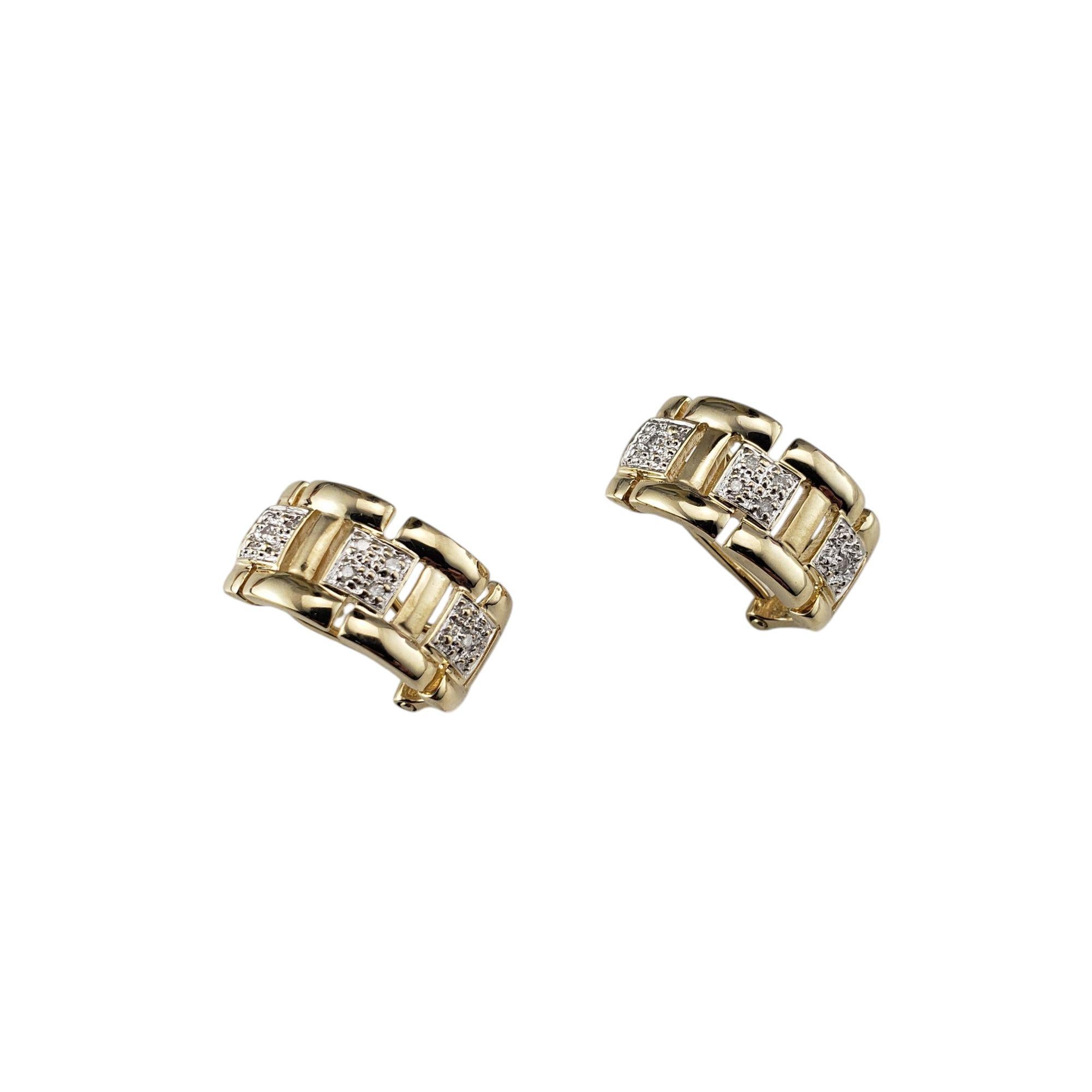 14 Karat Yellow Gold and Diamond Omega Back Earrings-

These elegant earrings offer the look of a traditional hoop but with a more structured, refined profile. Crafted in 14K yellow gold and each accented with six round brilliant cut diamonds. Omega
