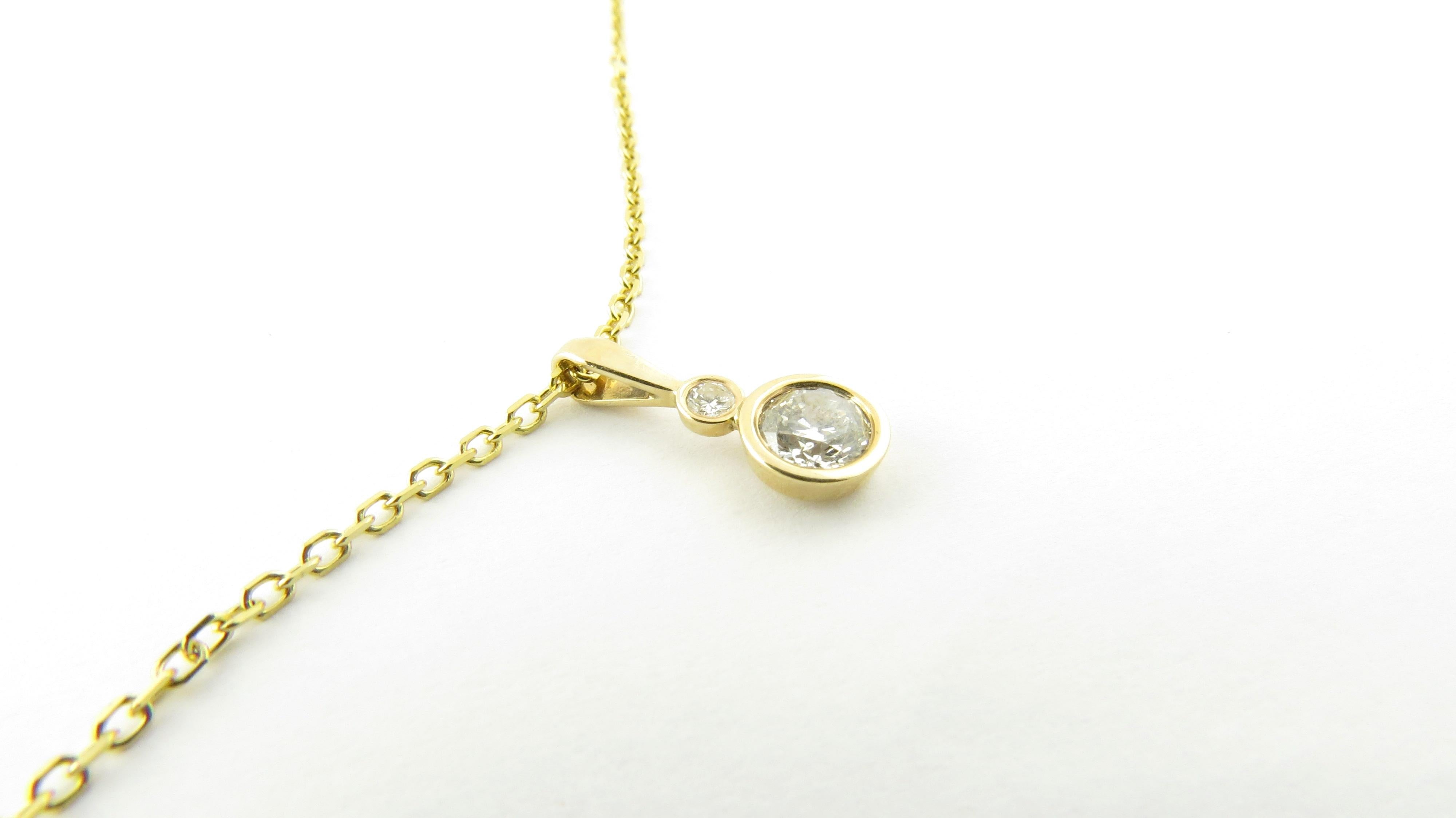 Vintage 14 Karat Yellow Gold Diamond Pendant Necklace-

This stunning pendant features two round brilliant cut diamonds (.04 ct., .50 ct.) bezel set in classic 14K yellow gold. Suspended from an elegant 16 
