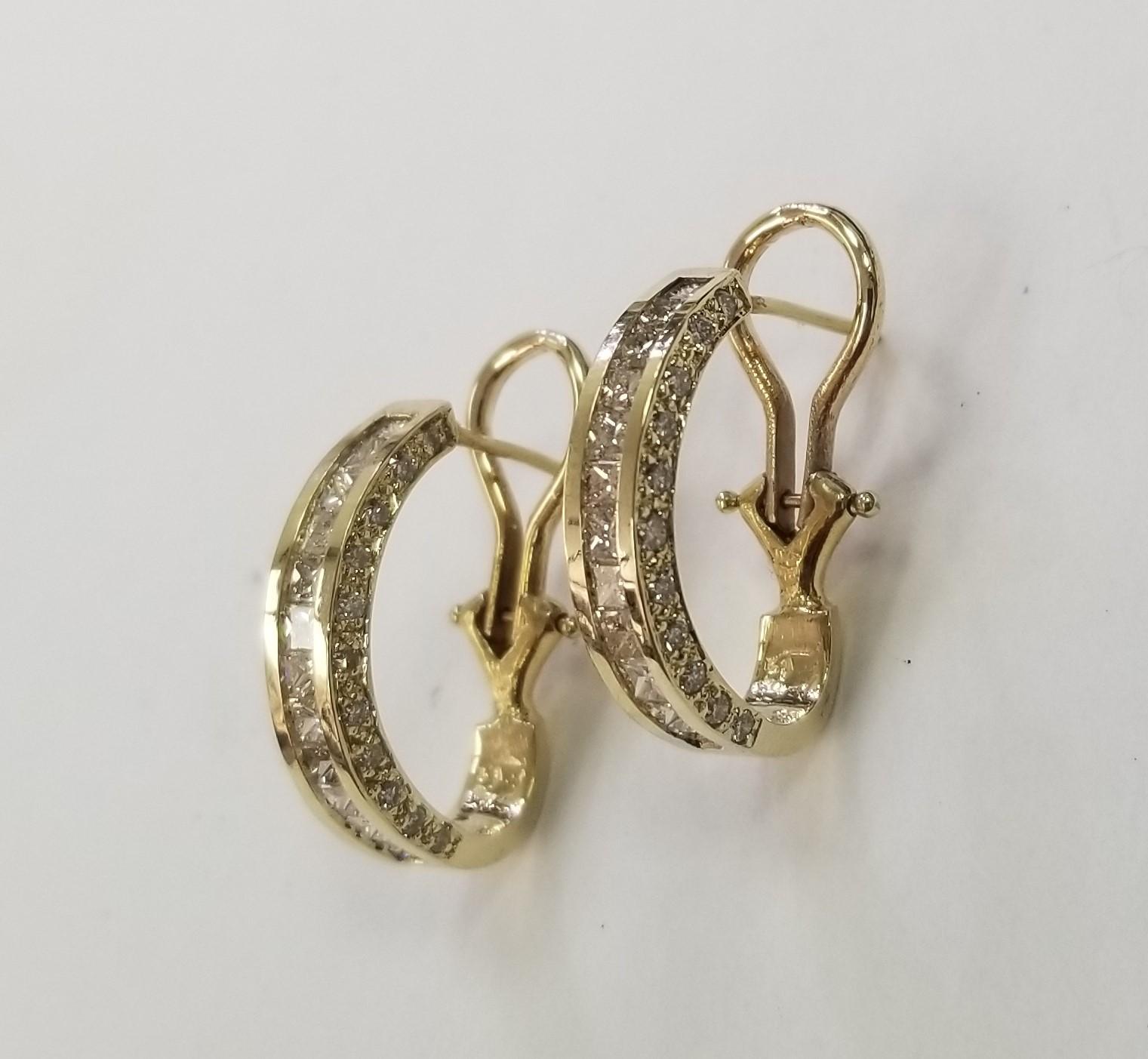 14 Karat Yellow Gold Diamond Princess and Round cut Earrings, containing 24 Princess cut diamonds  and 44 round full cut diamonds weighing 2.56cts.  
14k 5.6grams with omega backs.
