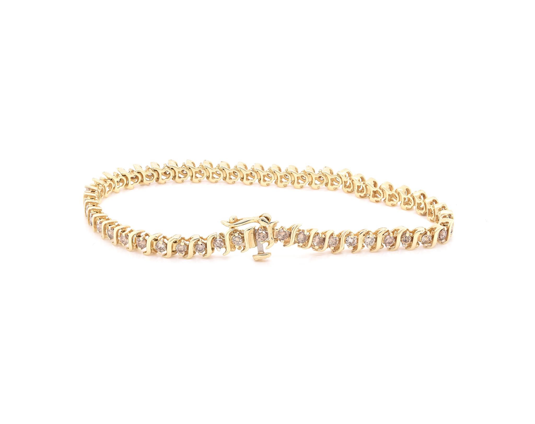 Designer: custom
Material: 14K yellow gold 
Diamond: 49 round cut = 1.96cttw
Color: Champagne
Clarity: SI1
Weight:  8.27 grams
Dimensions: bracelet measures 7-inches long
