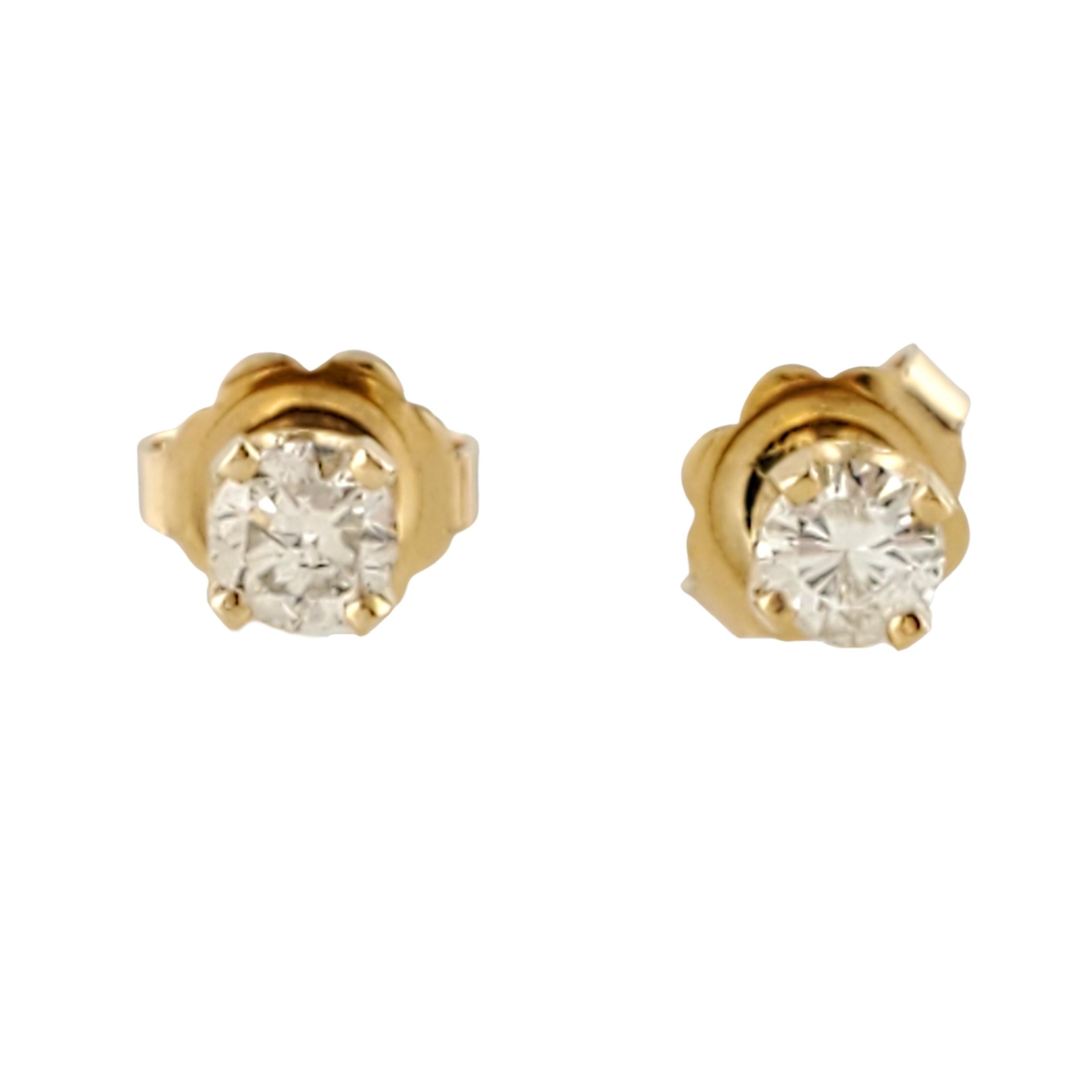 Vintage 14 Karat Yellow Gold Diamond Stud Earrings .28 ct.
These classic stud earrings each feature one round brilliant cut diamond (.14 ct.) in a four prong yellow gold setting. Approximate total diamond weight: .28 ct. Diamond color: J Diamond