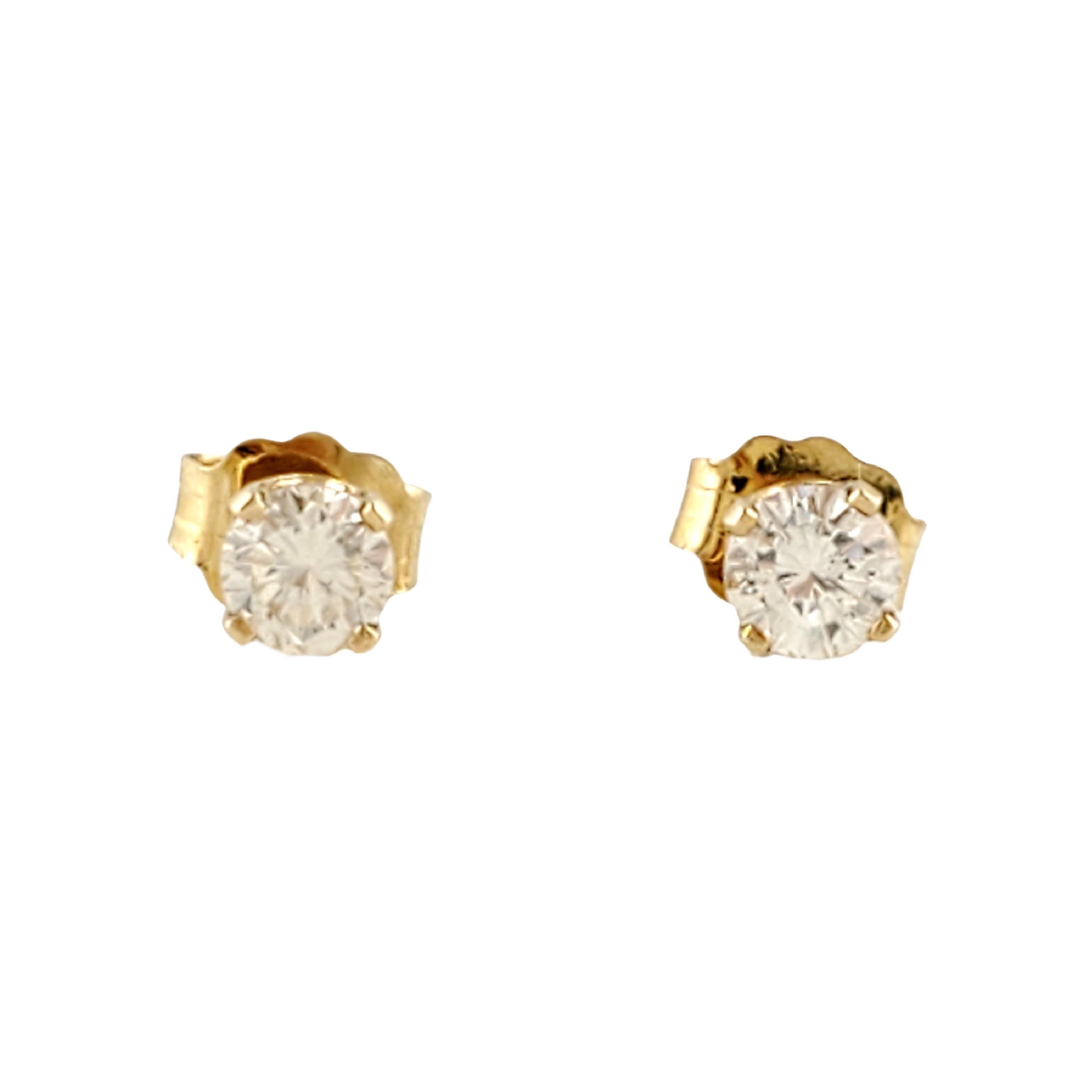 Vintage 14 Karat Yellow Gold Diamond Stud Earrings .40 ct.

These sparkling stud earrings each feature one round brilliant cut diamond (.20 ct. each) set in a classic four prong yellow gold setting. Push back closures.

Approximate total diamond