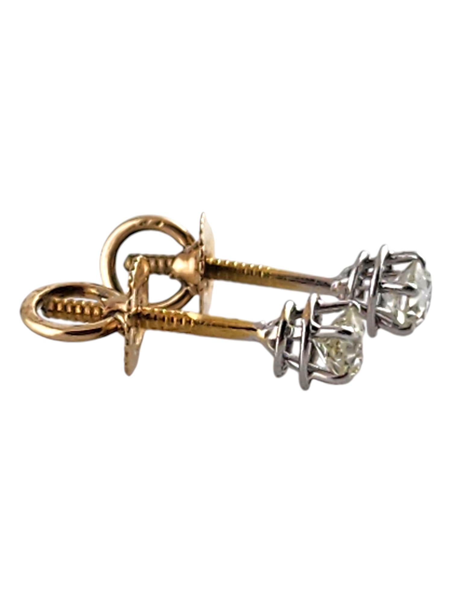 These sparkling stud earrings each feature one European cut diamond set in classic 14K yellow gold. Screw back closures.

Approximate total diamond weight: .40 ct.

Diamond color: K

Diamond clarity: SI1

Size: 5 mm

Weight: 1.0 gr./ 0.6