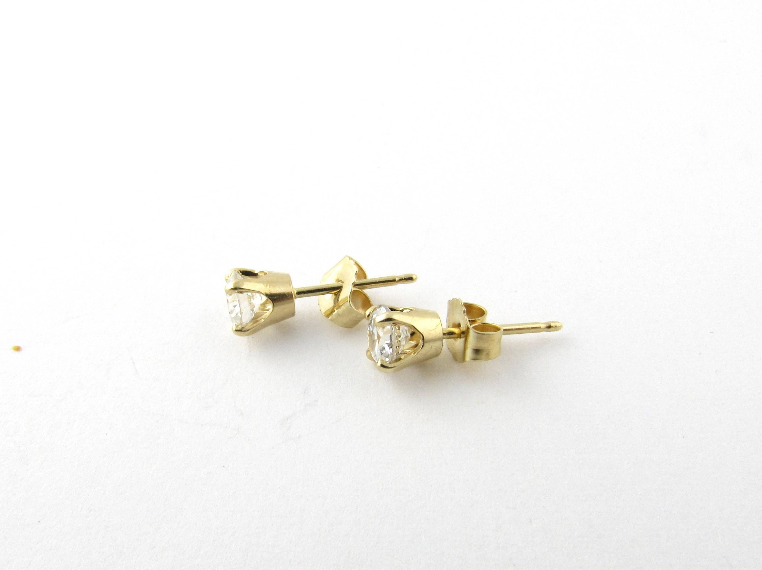 Vintage 14 Karat Yellow Gold Diamond Stud Earrings .60 ct.
These classic stud earrings each feature one round brilliant cut diamond (.30 ct.) in a four prong yellow gold setting. Push back closures. Approximate total diamond weight: .60 ct. Diamond