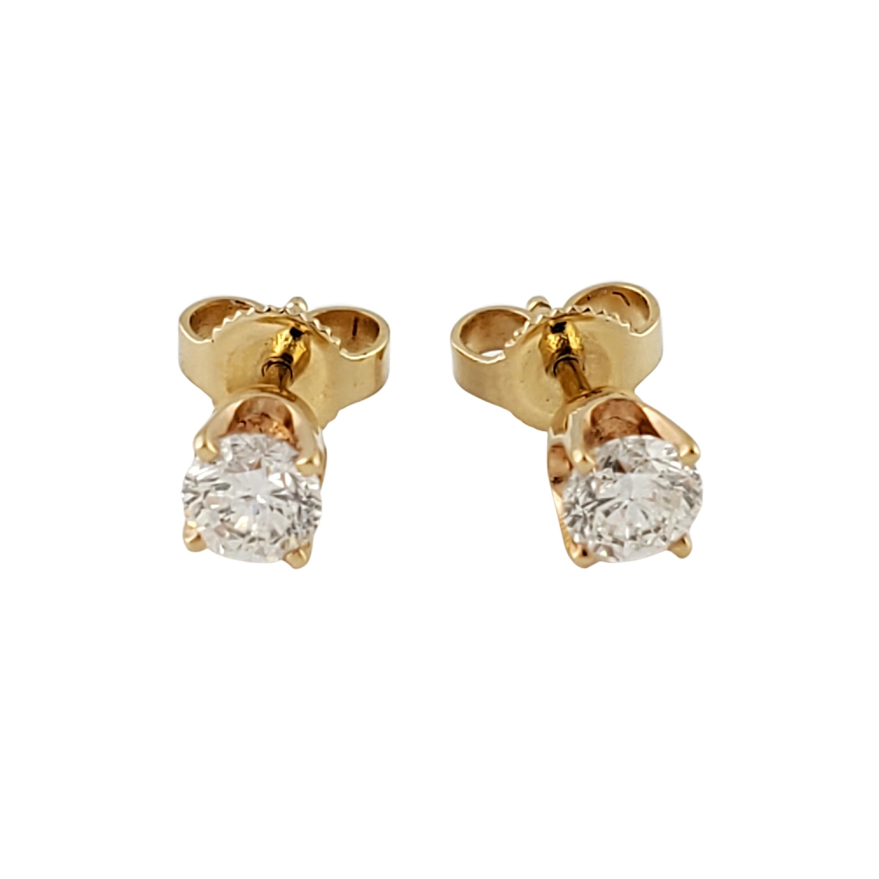 Round Cut 14 Karat Yellow Gold Diamond Stud Earrings .60 Carat For Sale