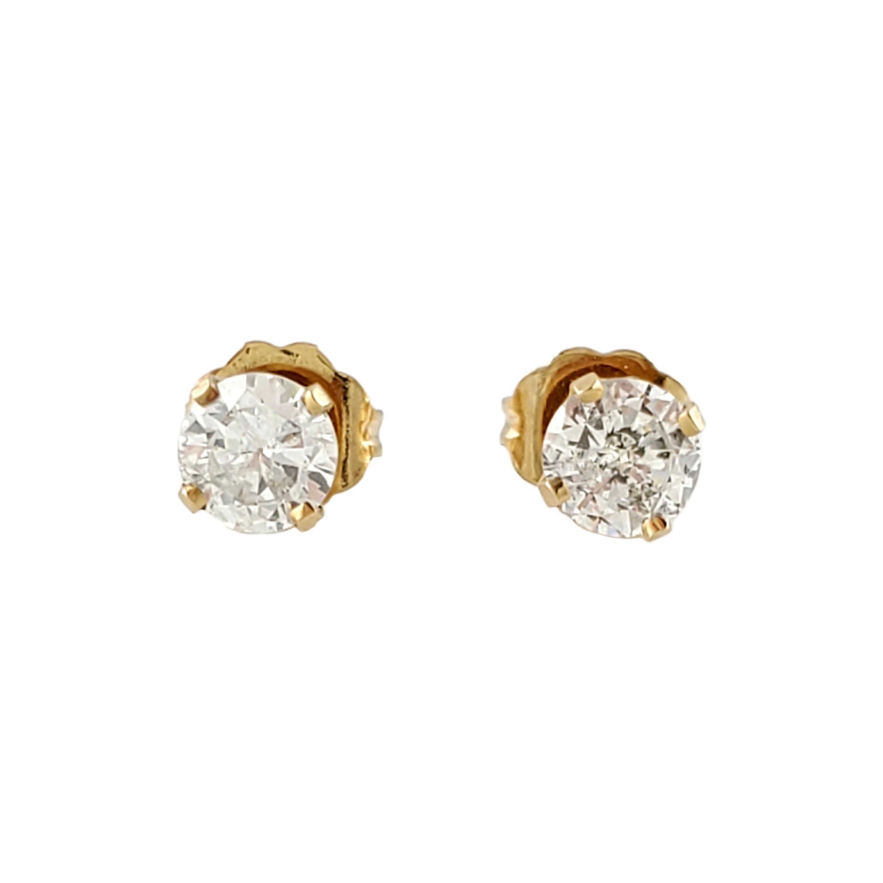 Vintage 14 Karat Yellow Gold Diamond Stud Earrings .72 ct. 
These classic stud earrings each feature one round brilliant cut diamond (.36 ct.) in a four prong yellow gold setting. Push back closures. Approximate total diamond weight: .72 ct. Diamond