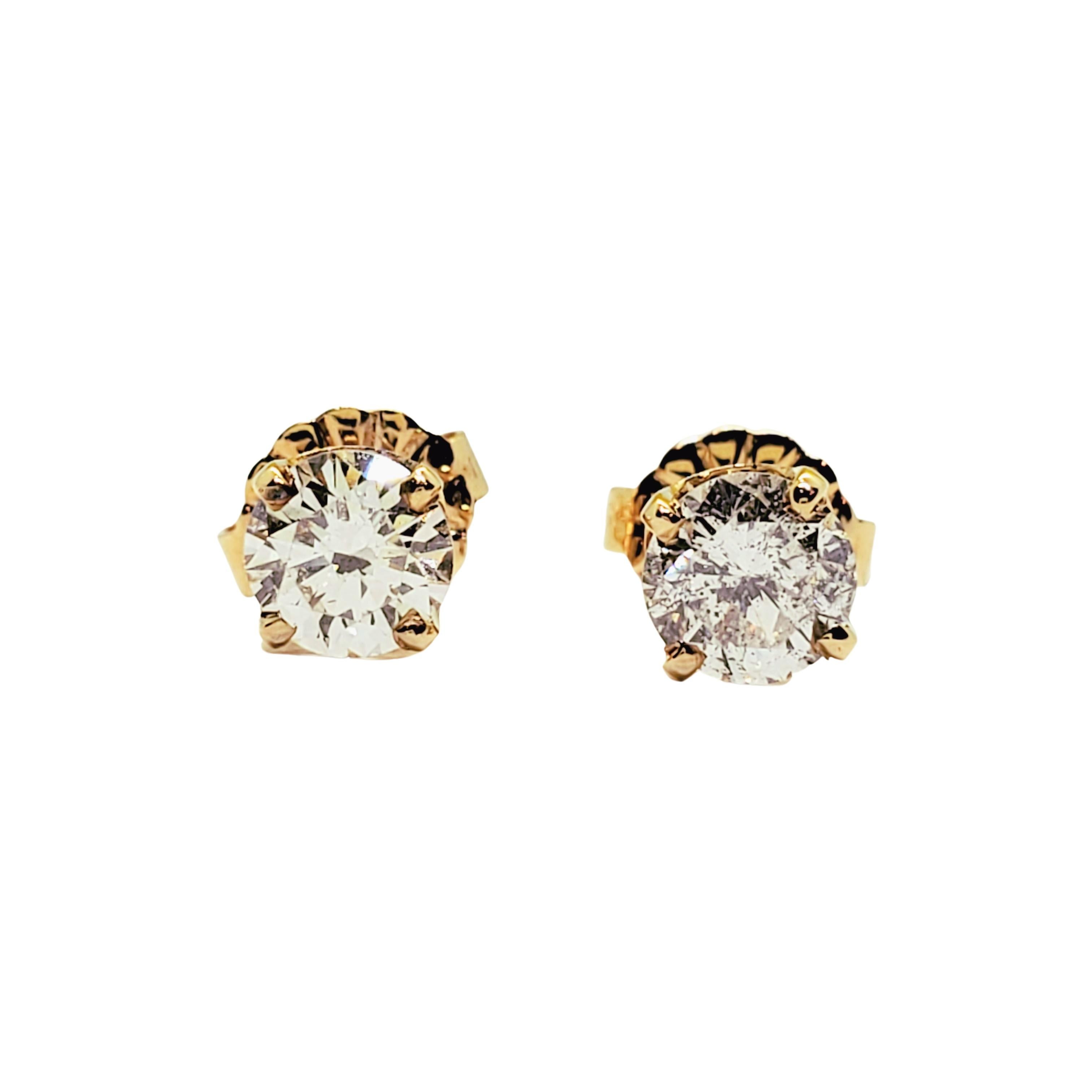 Vintage 14 Karat Yellow Gold Diamond Stud Earrings (.73 ct. twt.)

These sparkling stud earrings each feature one round brilliant cut diamond set in classic 14K yellow gold. Push back closures.

Approximate total diamond weight: .73 ct.

Diamond