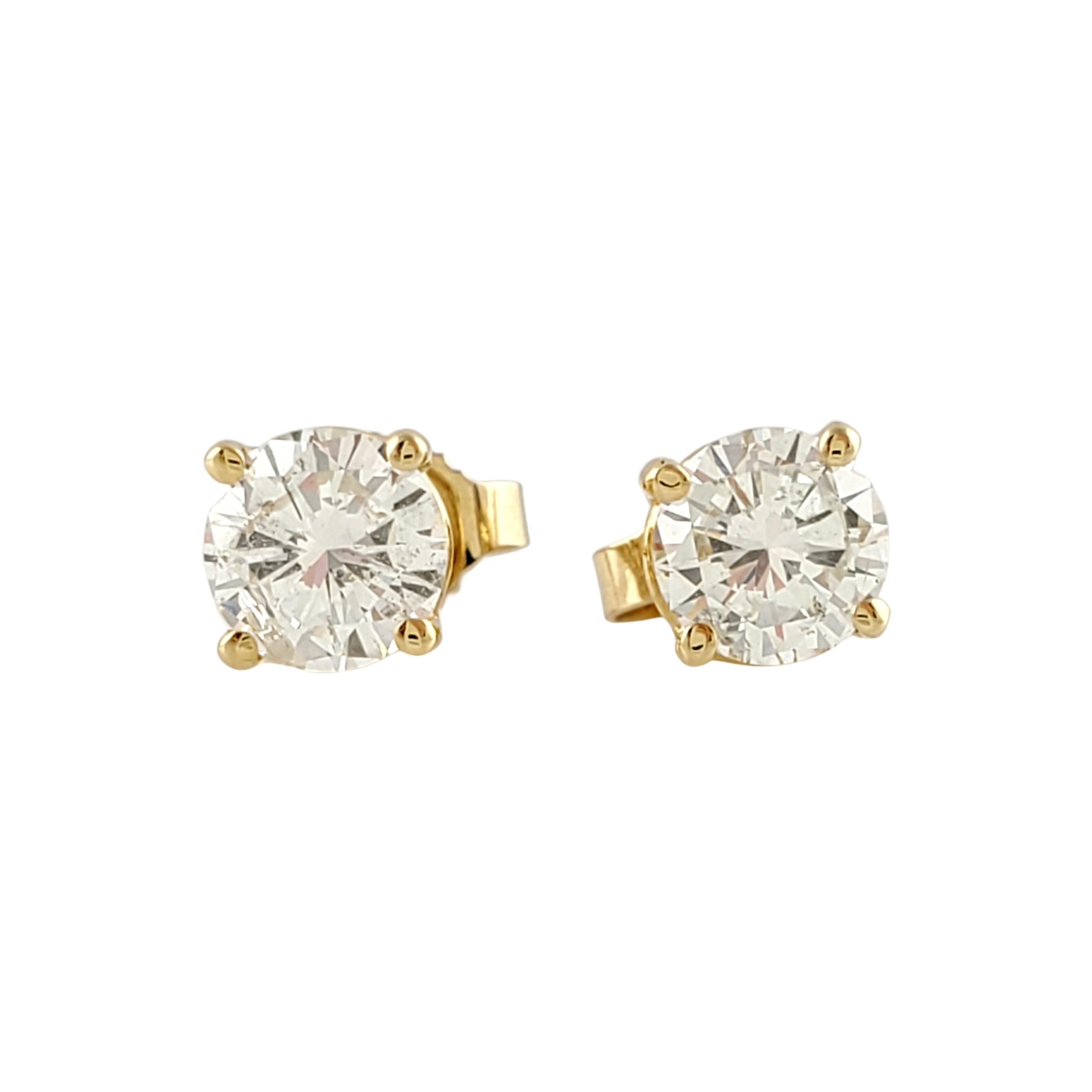 Vintage 14 Karat Yellow Gold Diamond Stud Earrings .90 ct. twt.

These sparkling stud earrings each feature one round brilliant cut diamond set in classic 4 prong 14K yellow gold. 
Push back closures.

Approximate total diamond weight: .90