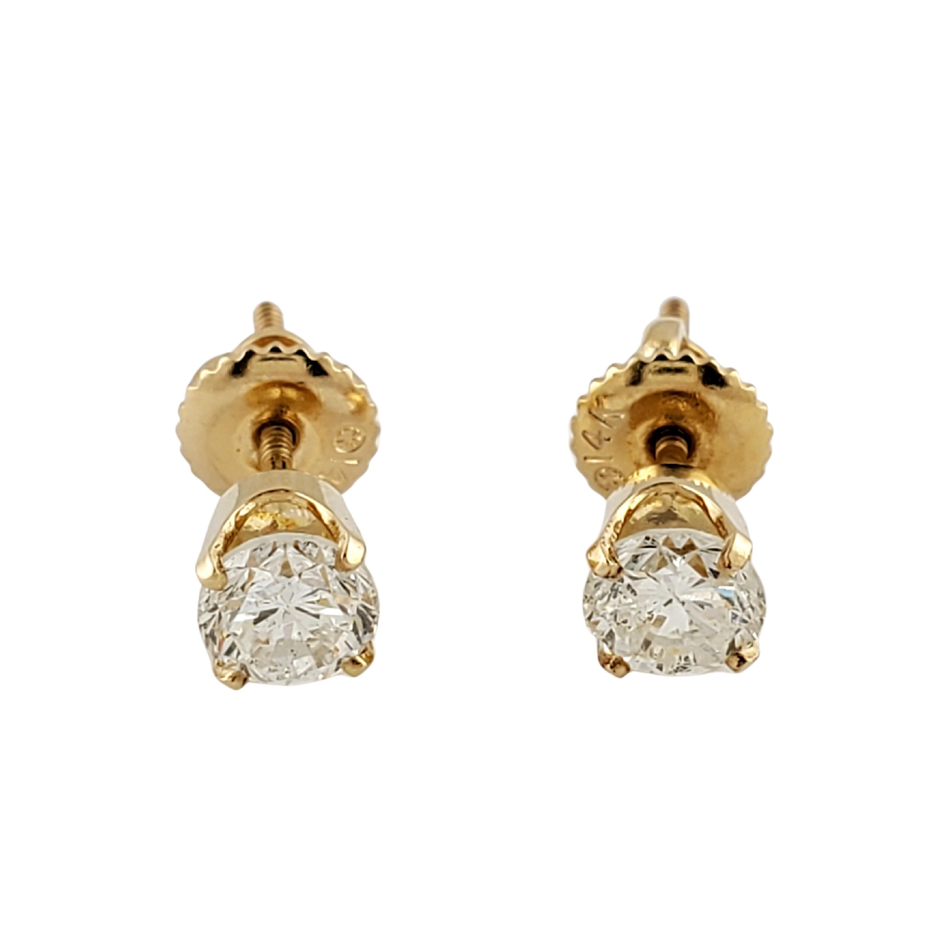 14 Karat Yellow Gold Diamond Stud Earrings .90 ct. twt.-

These sparkling stud earrings each feature one round brilliant cut diamond set in classic 14K yellow gold.  Screw back closures.

Approximate total diamond weight:  .90 ct.

Diamond color: 