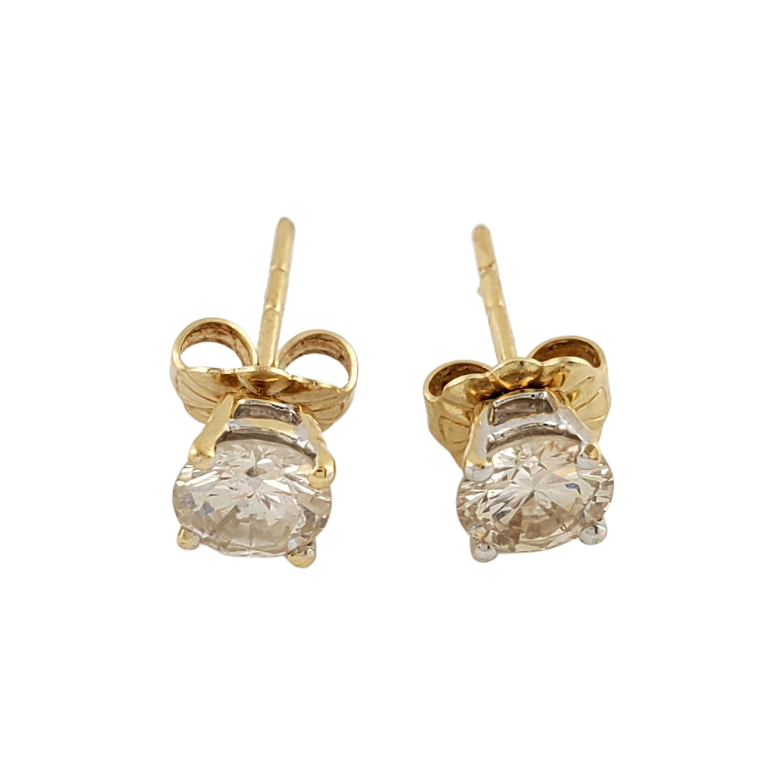 14 Karat Yellow Gold Diamond Stud Earrings-

These sparkling earrings each feature one round brilliant cut diamond set in classic 14K yellow gold.  Push back closures.

Approximate total diamond weight:  .86 ct.

Diamond color:  J-K

Diamond