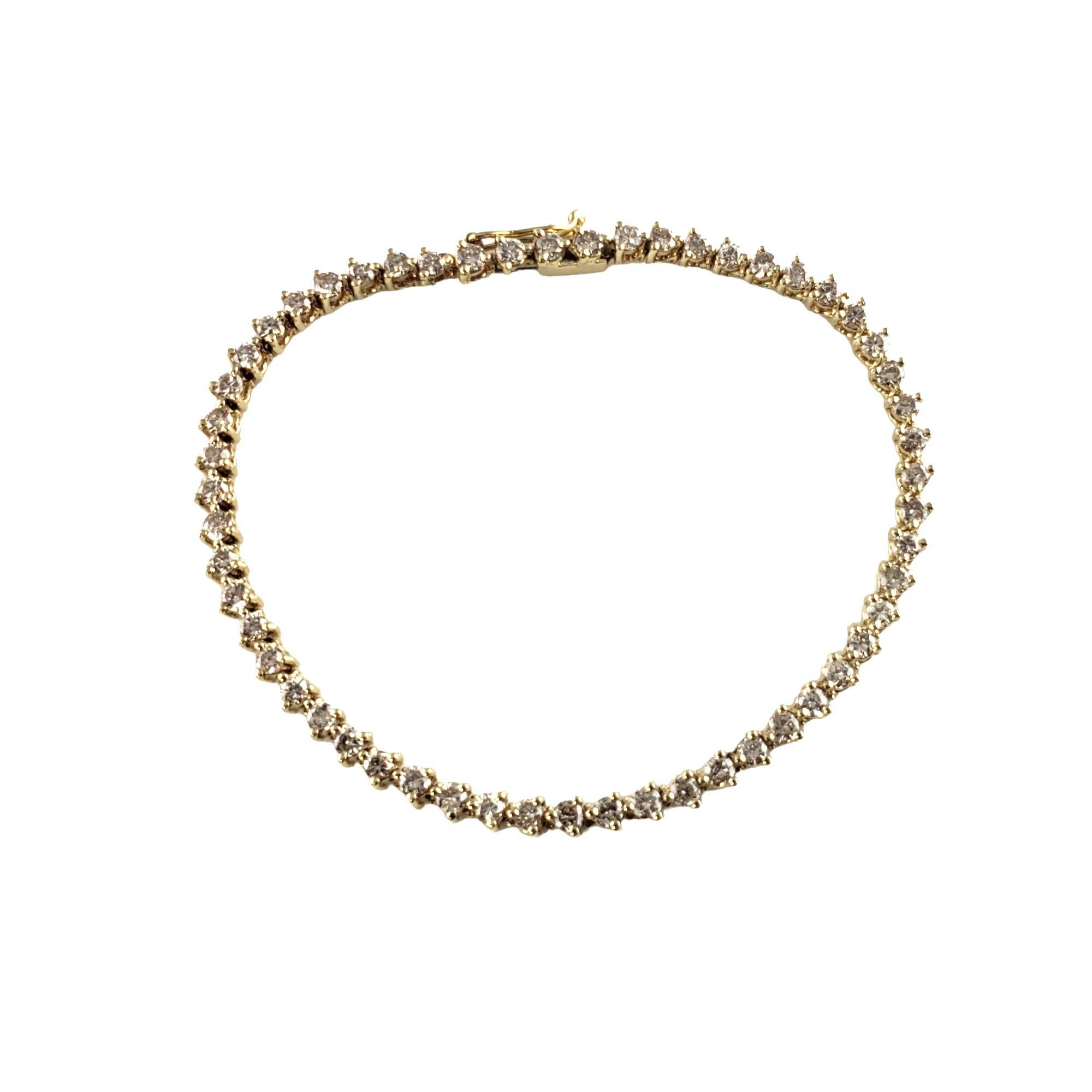 Vintage 14 Karat Yellow Gold Diamond Tennis Bracelet-

This sparkling tennis bracelet features 55 round brilliant cut diamonds* set in classic 14K yellow gold. Width: 3 mm.

*Chip noted to one stone not visible to naked eye.

Approximate total