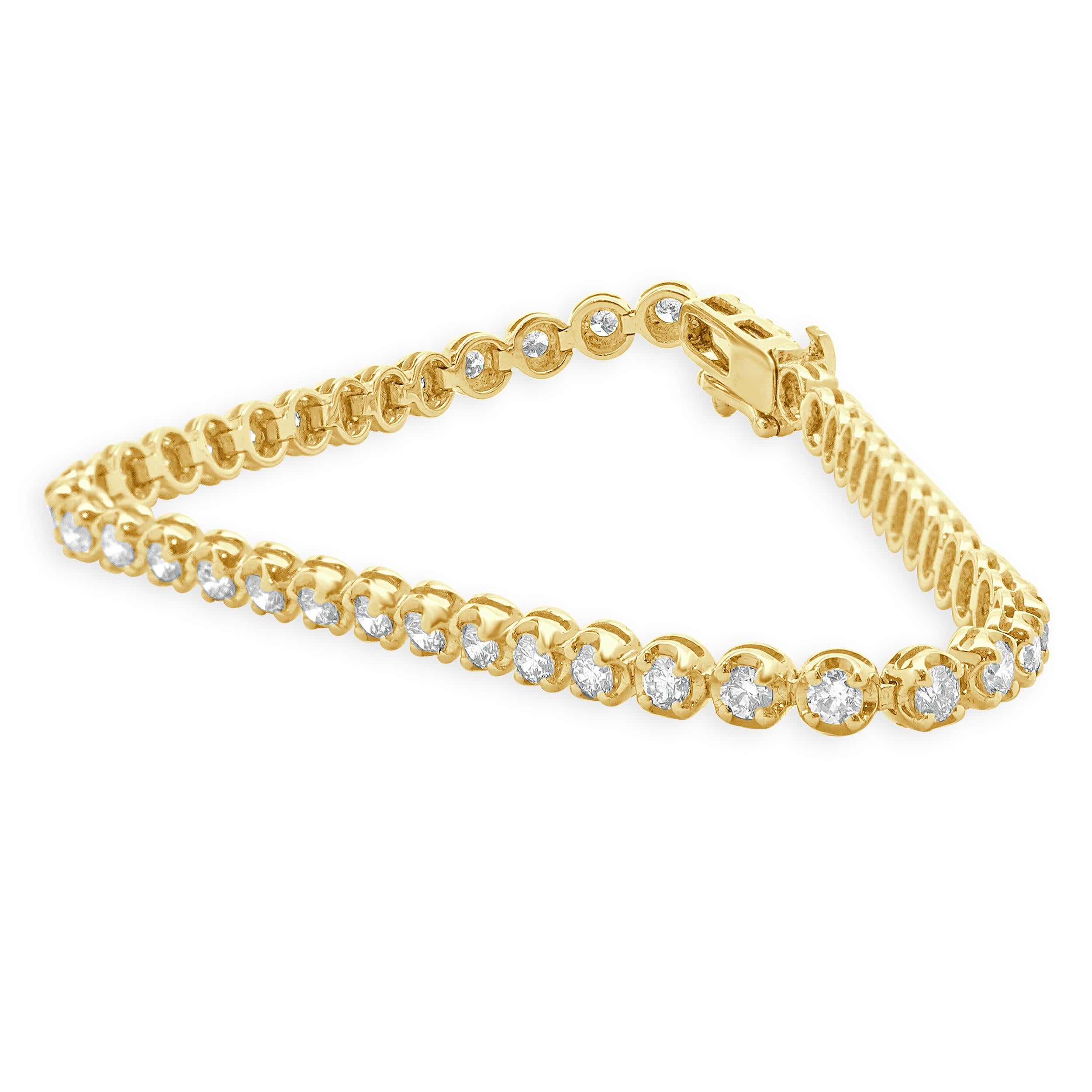 Designer: custom design
Material: 14K yellow gold
Diamond: 47 round brilliant cut = 3.00cttw
Color: G / H
Clarity: VS-SI1
Dimensions: bracelet will fit up to a 7-inch wrist
Weight: 7.37 grams

