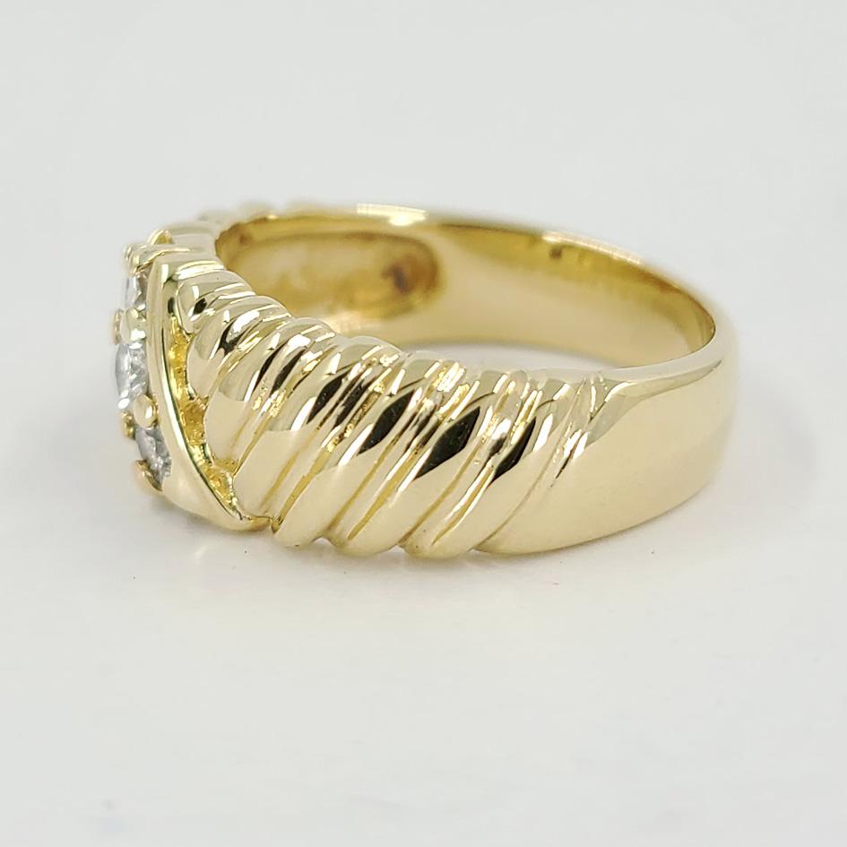 14 Karat Yellow Gold Ring With Rope Design Featuring 3 Round Brilliant Cut Diamonds Totaling 0.12 Carats Of SI Clarity & H Color. Current Finger Size 6.5; Purchase Includes One Sizing Service Up Or Down 2 Sizes. Finished Weight Is 6.5 Grams.