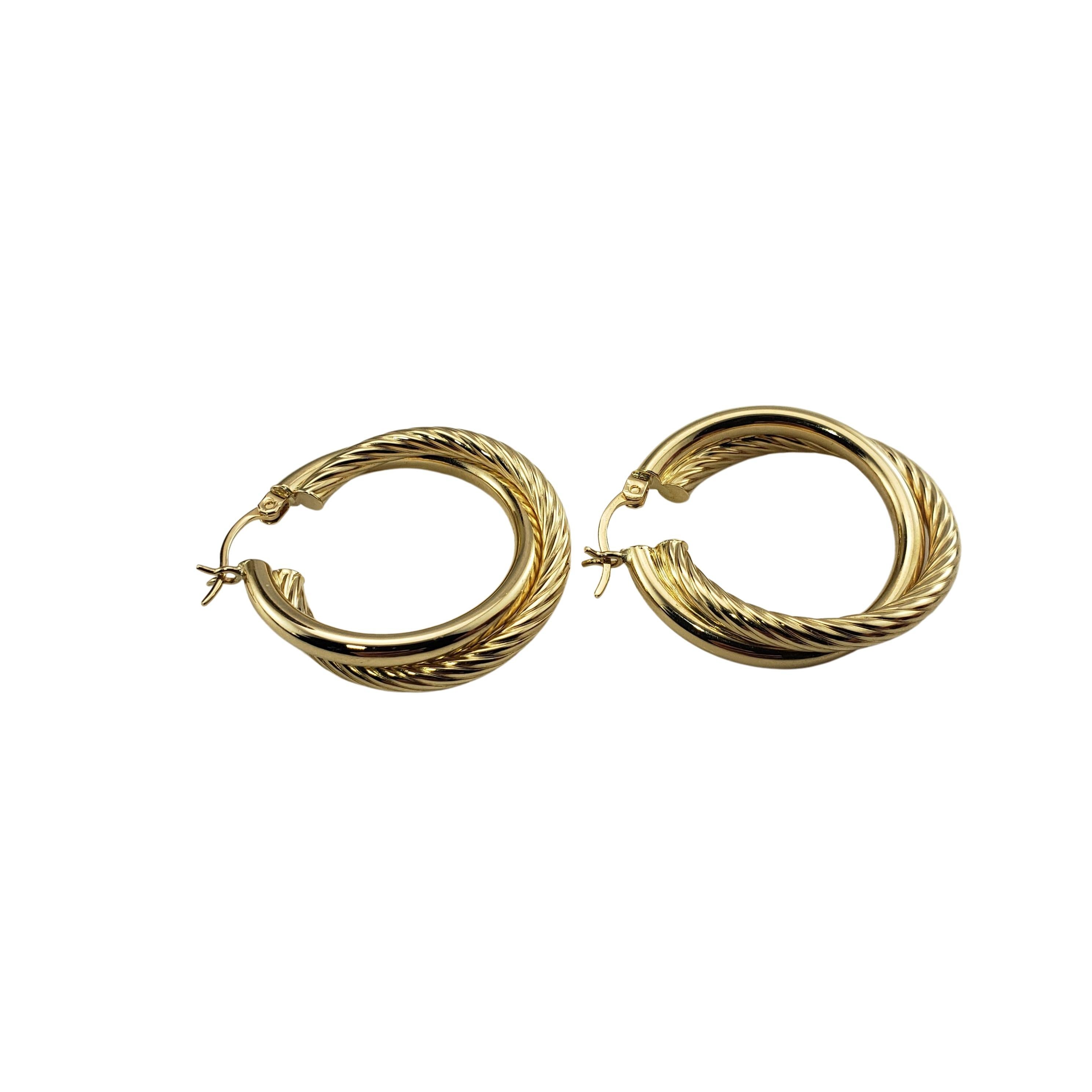 14 Karat Yellow Gold Double Hoop Earrings-

These lovely double hoop earrings are crafted in beautifully detailed 14K yellow gold.

Size: 27 mm x 3 mm

Weight:    3.0 dwt. /   4.7 gr.

Stamped:  14K

Very good condition, professionally