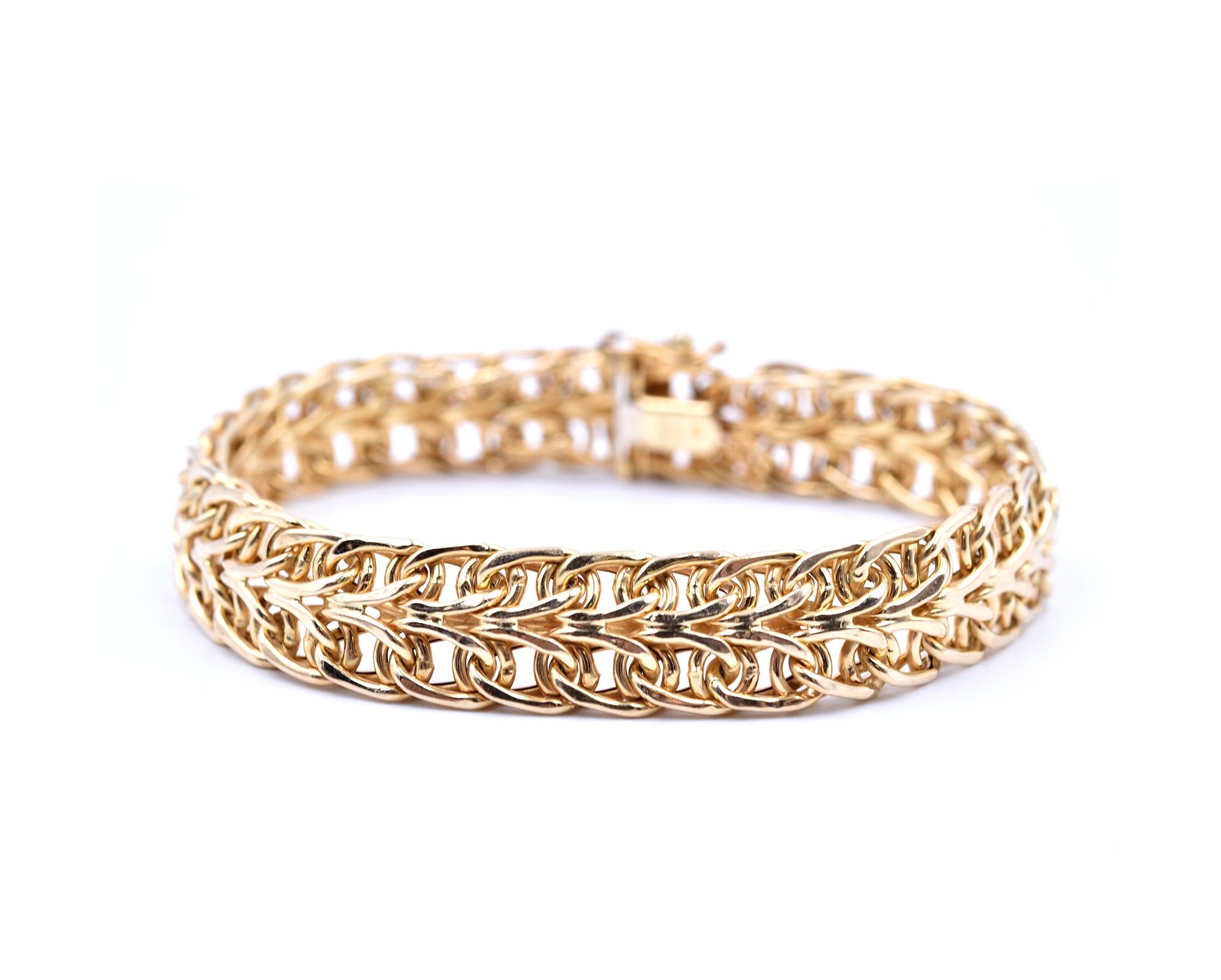 Designer: custom design
Material: 14k yellow gold
Dimensions: bracelet is 7-inch long and 10.40mm wide 
Weight: 9.90 grams
