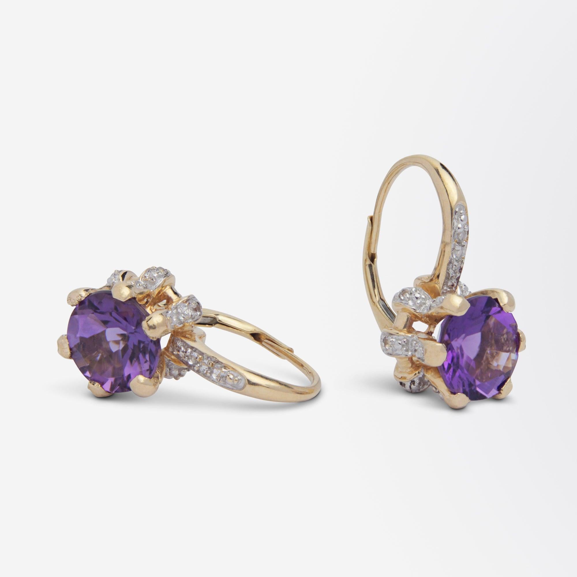 A fun pair of drop earrings featuring a central cut amethyst set with cubic zirconias. The crown shaped claw setting of each earring contains a central brilliant cut topaz. The claws of each setting are claw set with brilliant cut cubic zirconias as