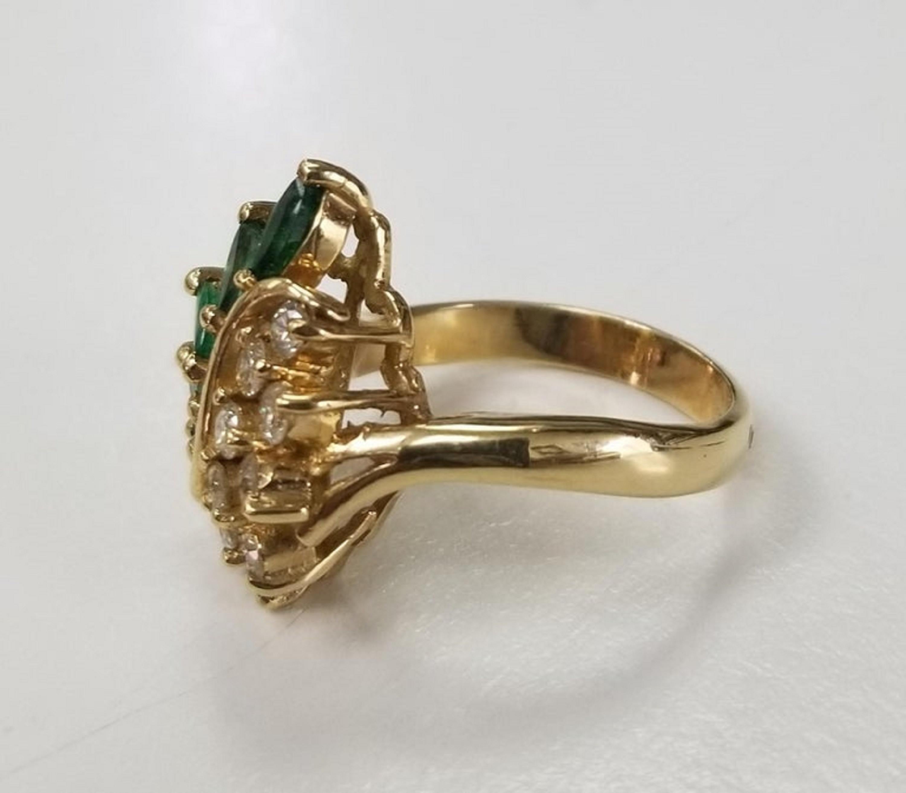 Contemporary 14 Karat Yellow Gold Emerald and Diamond Cluster Ring For Sale