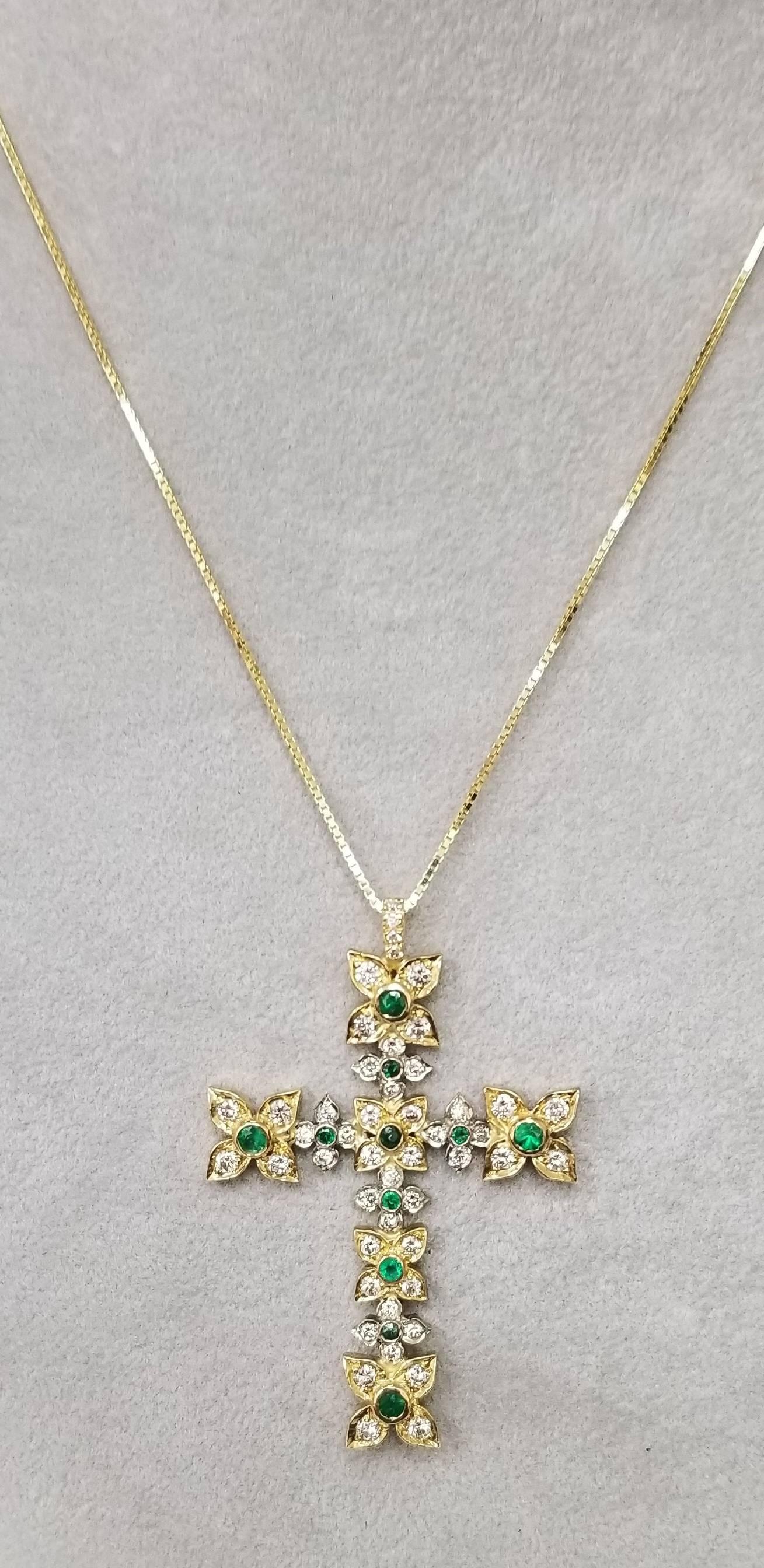 14k yellow gold emerald and diamond cross, containing 11 emerald weighing .50pts. and 44 round full cut diamonds weighing 1.50cts.  set in a flower style setting on a 16 inch box chain.