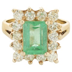 14 Karat Yellow Gold Emerald and Diamond Halo Ring