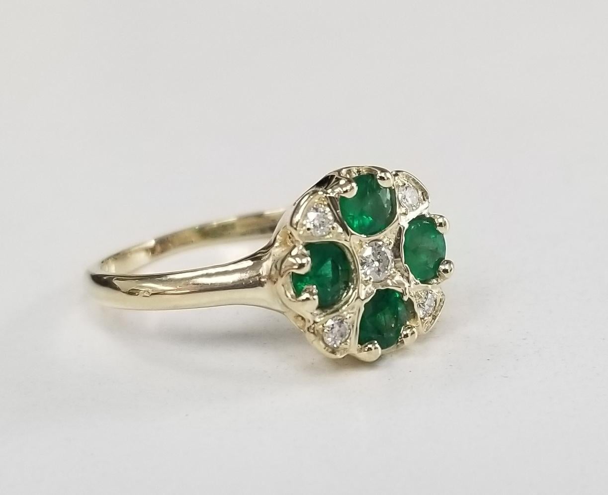 14k yellow gold emerald and diamond ring, containing 4 round cut emeralds of fine quality weighing .70pts. and 5 round full cut diamonds of very fine quality weighing .13pts. in an 