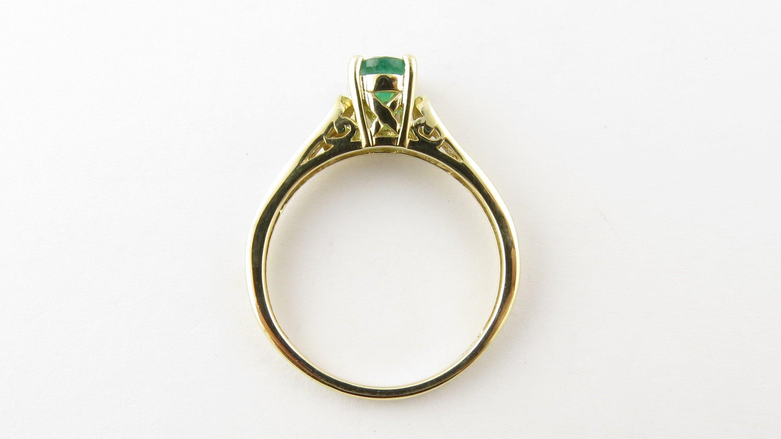 Vintage 14 Karat Yellow Gold Emerald and Diamond Ring Size 9.25- This lovely ring features one oval genuine emerald (7 mm x 5 mm) accented with 14 round brilliant cut diamonds and set in classic 14K yellow gold. Setting height: 8 mm. Shank: 1.5 mm.