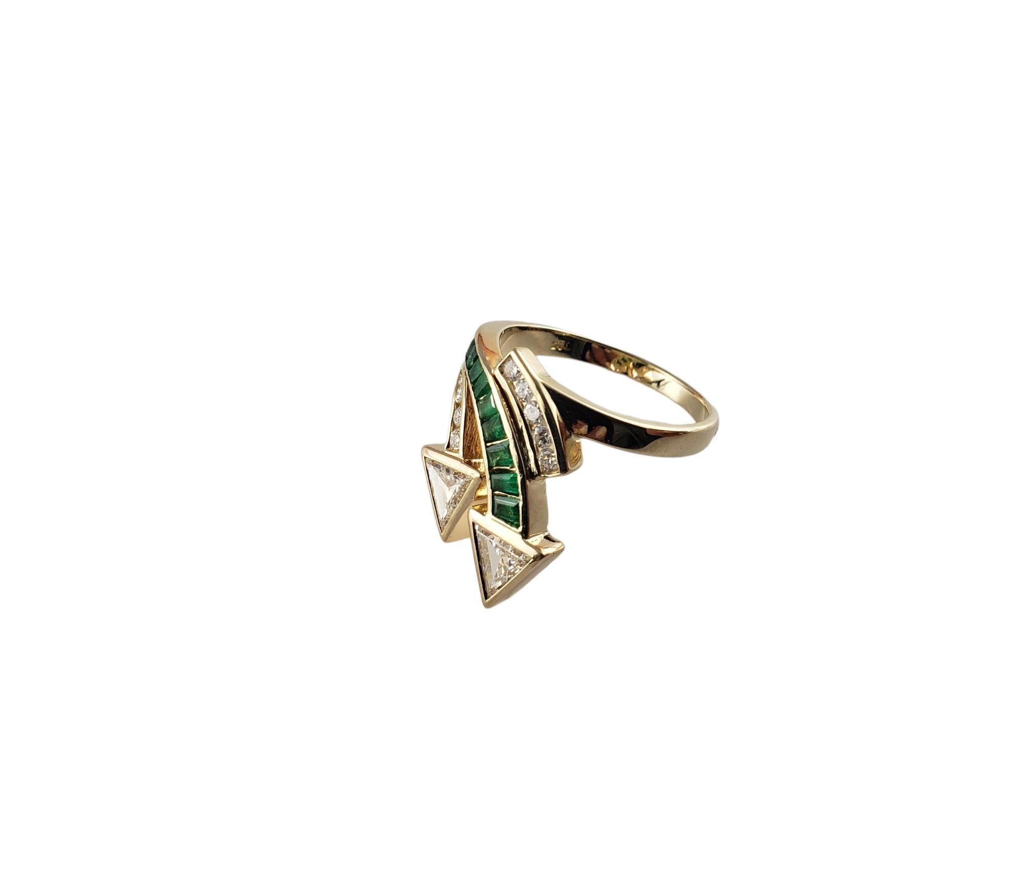 Vintage 14 Karat Yellow Gold Emerald and Diamond Ring Size 6.5 JAGi Certified-

This stunning ring features nine baguette emeralds, two triangle brilliant cut diamonds and nine round brilliant cut diamonds set in classic 14K yellow gold. Width: 19