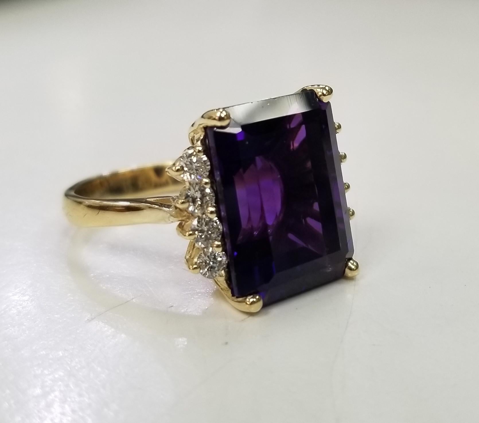 14k yellow gold amethyst and diamond ring, containing 1 emerald cut  weighing 13.55cts. and 8 round diamonds weighing .55pts.  This ring is a size 5.75 but we will size to fit for free.