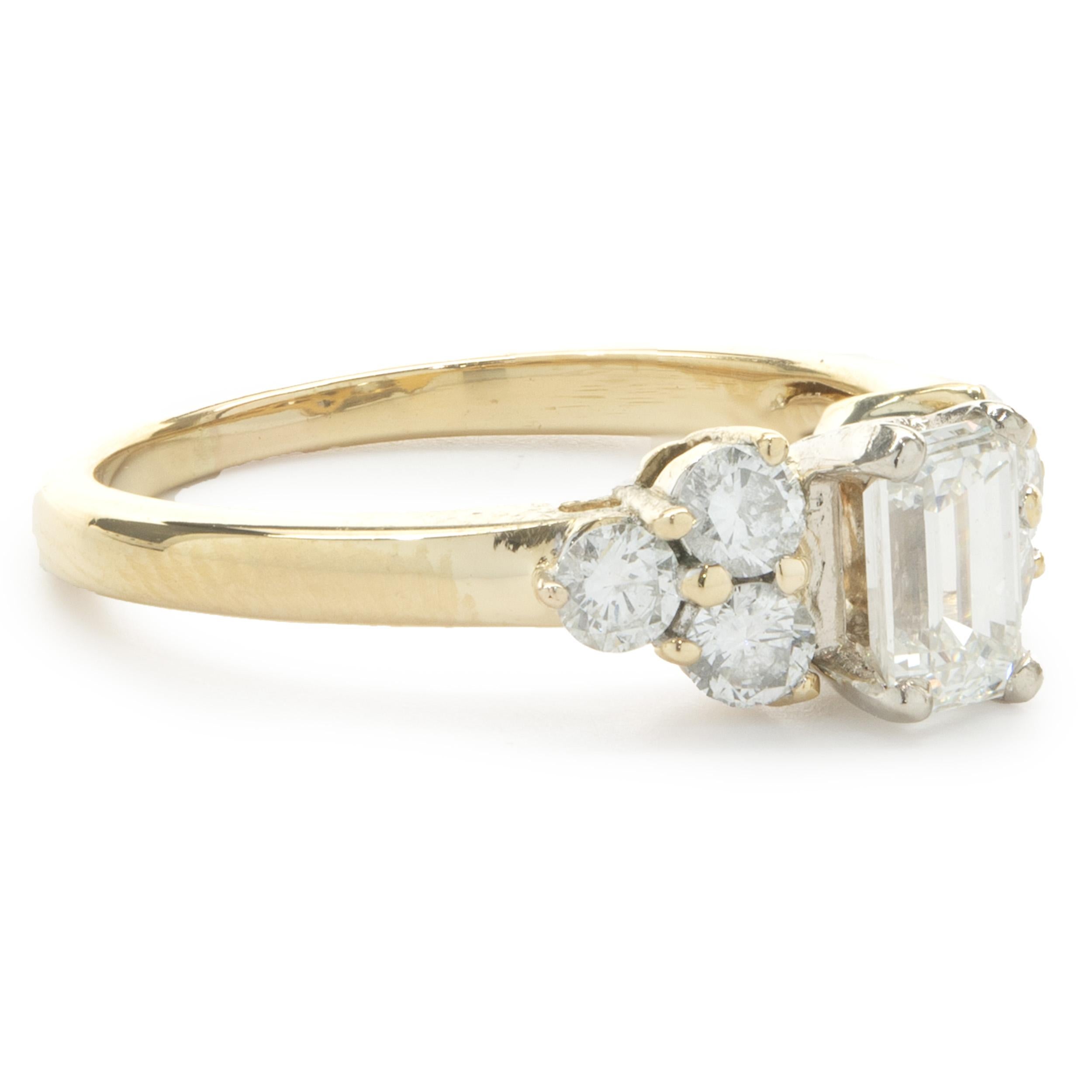 Designer: custom
Material: 14K yellow gold
Diamond: 1 emerald cut = 0.70ct
Color: I 
Clarity: VS2
Diamond: 6 round brilliant = 0.48cttw 
Color: G
Clarity: SI1
Ring Size: 7.75 (please allow two additional shipping days for sizing