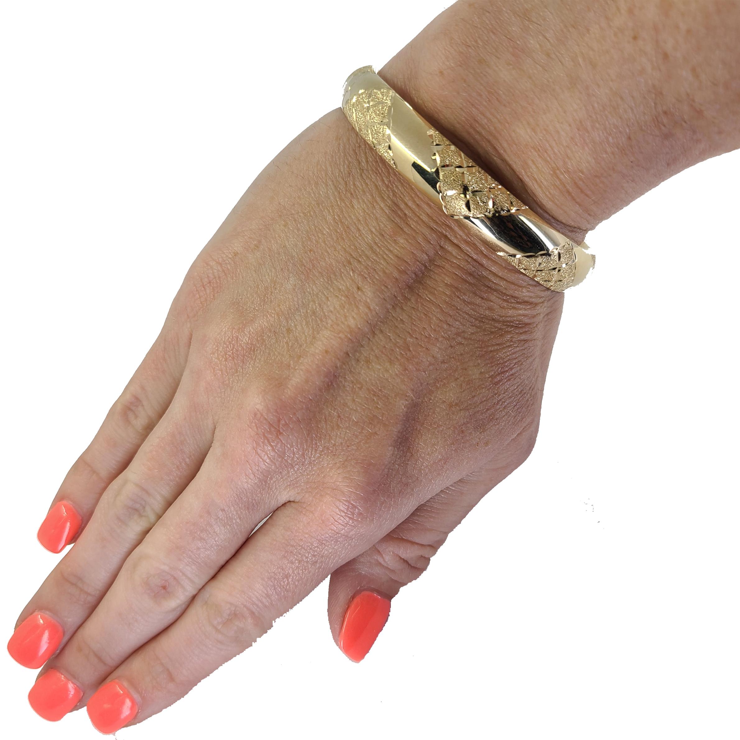14 Karat Yellow Gold Hinged Bangle Bracelet With Engraved Pyramid Texture Detail. Domed Design With 2.37 Inch Inner Diameter, Fits Up to 7 Inch Wrist. Finished Weight Is 15.6 Grams.