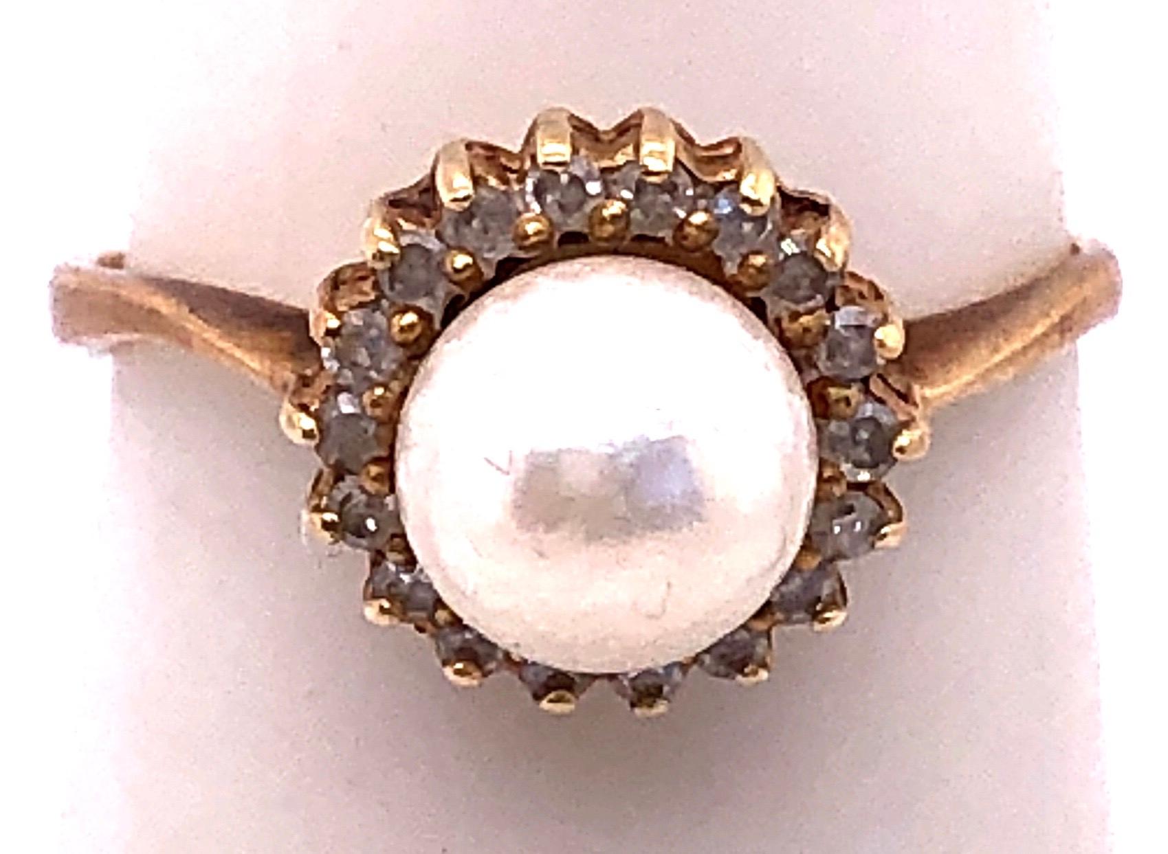 14 Karat Yellow Gold Fashion Pearl Ring with Diamonds Size 6.75.
5 mm diameter pearl.
2.4 grams total weight.

