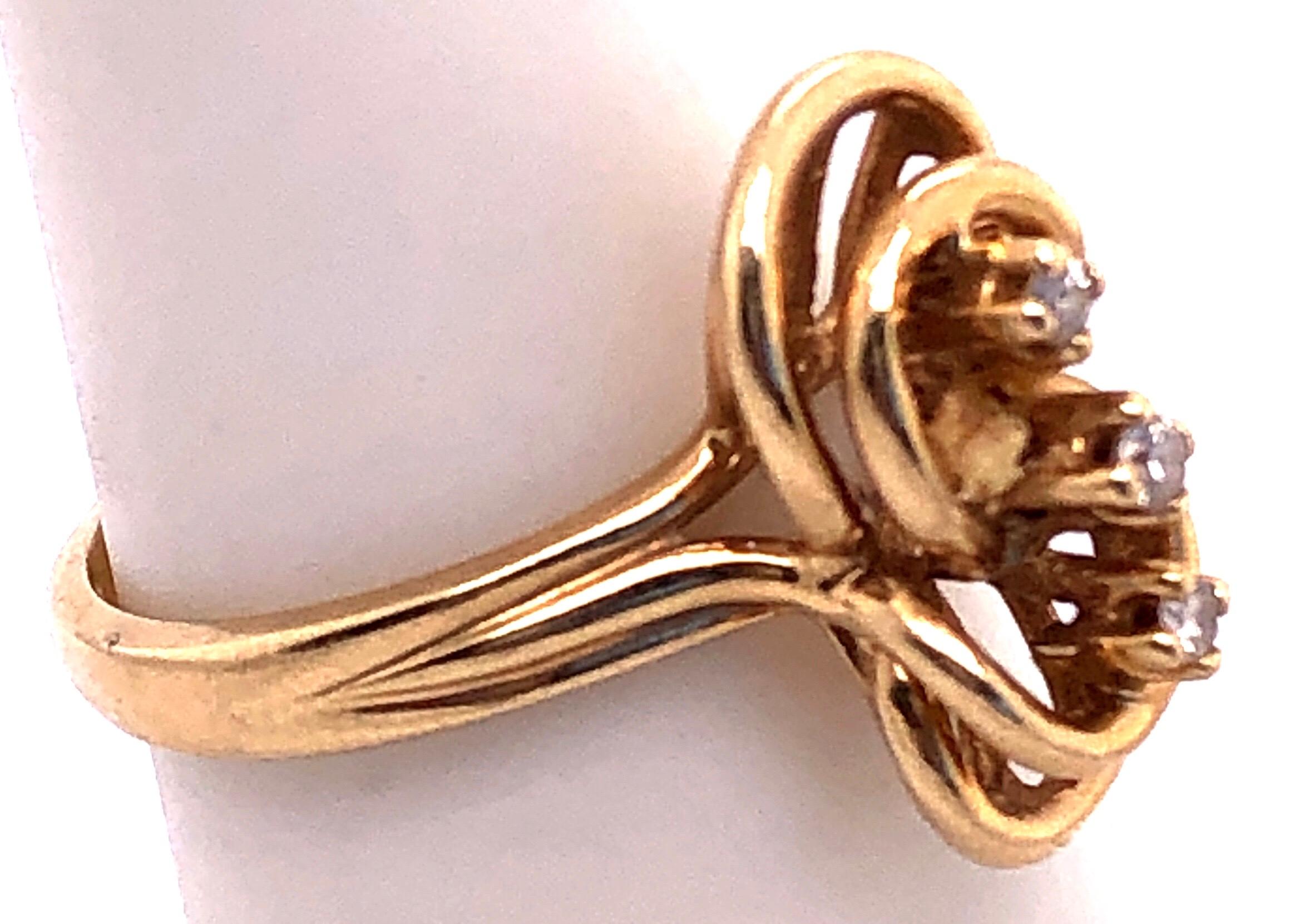 14 Karat Yellow Gold Fashion Ring with Three Round Diamonds Size 6.
0.09 total diamond weight.
3.8 grams total weight.
