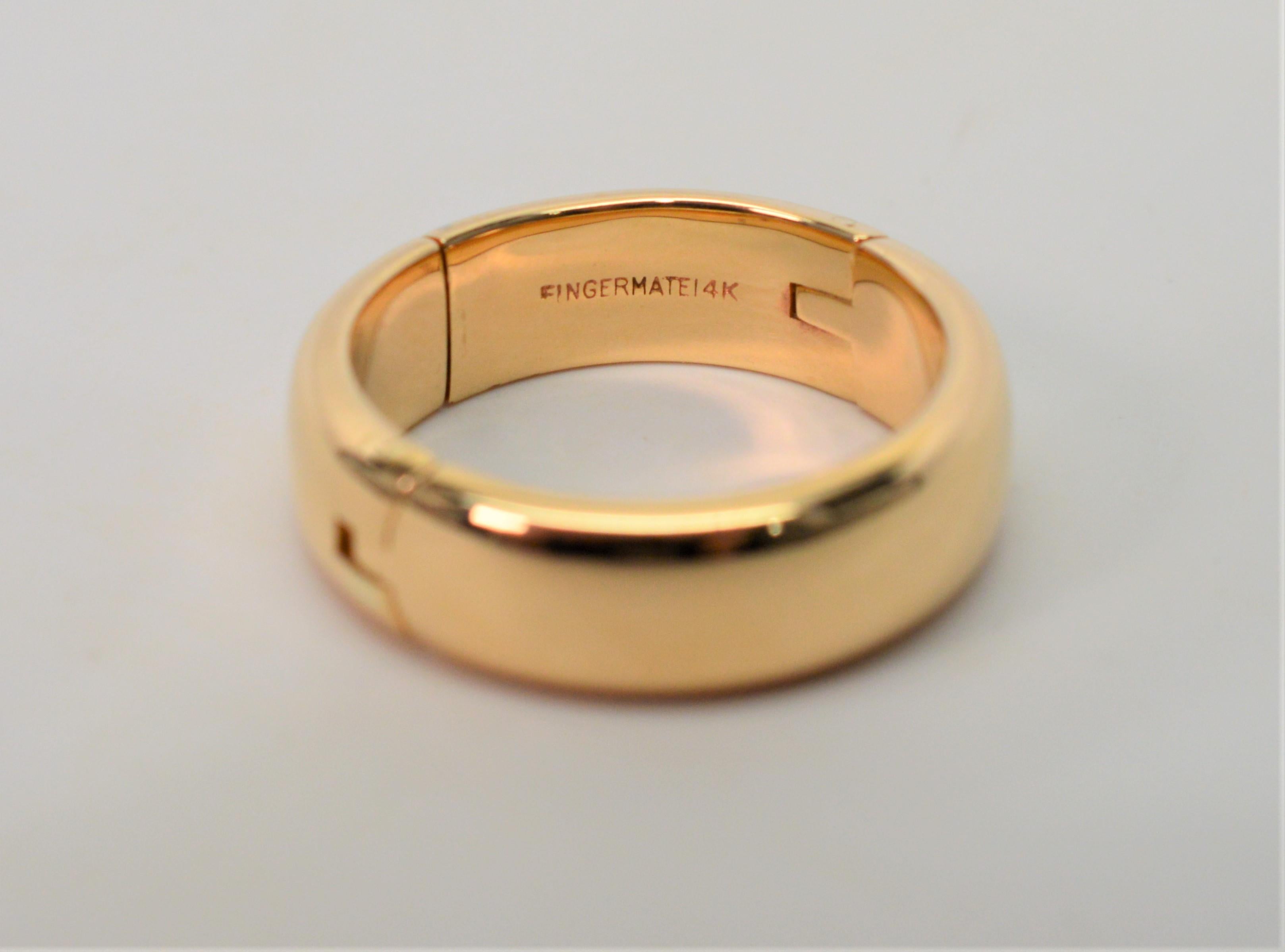 Substantial Gold Band in 14 Karat Yellow Gold crafted with a unique Fingermate adjustable hinge to easily fit this ring over larger knuckles with snap closure to fit when comfortably in place.  In size 9, band measures 6.6mm wide x 2.4mm thick. New