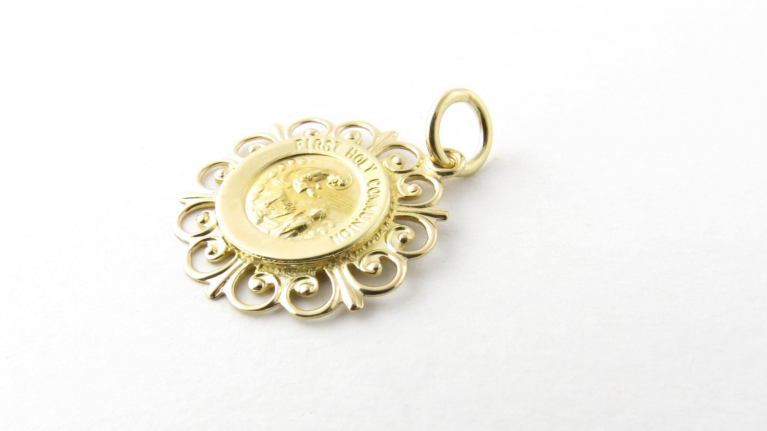 Vintage 14 Karat Yellow Gold First Holy Communion Charm- 
Commemorate that blessed day with this lovely medal beautifully detailed in 14K yellow gold. 
Size: 18 mm x 18 mm (actual charm) 
Weight: 0.9 dwt. / 1.4 gr. 
Stamped: 14K 
Very good