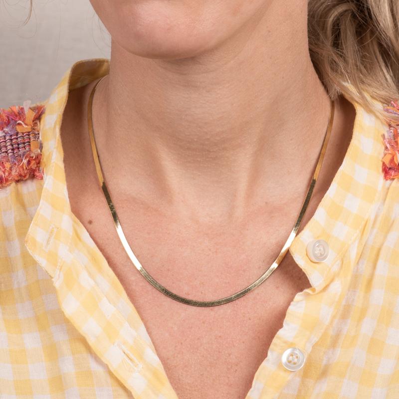 A flexible herringbone necklace crafted in 14 karat yellow gold with a lobster clasp closure. This necklace can be worn alone or layered with other necklaces. 
Measurements: 18