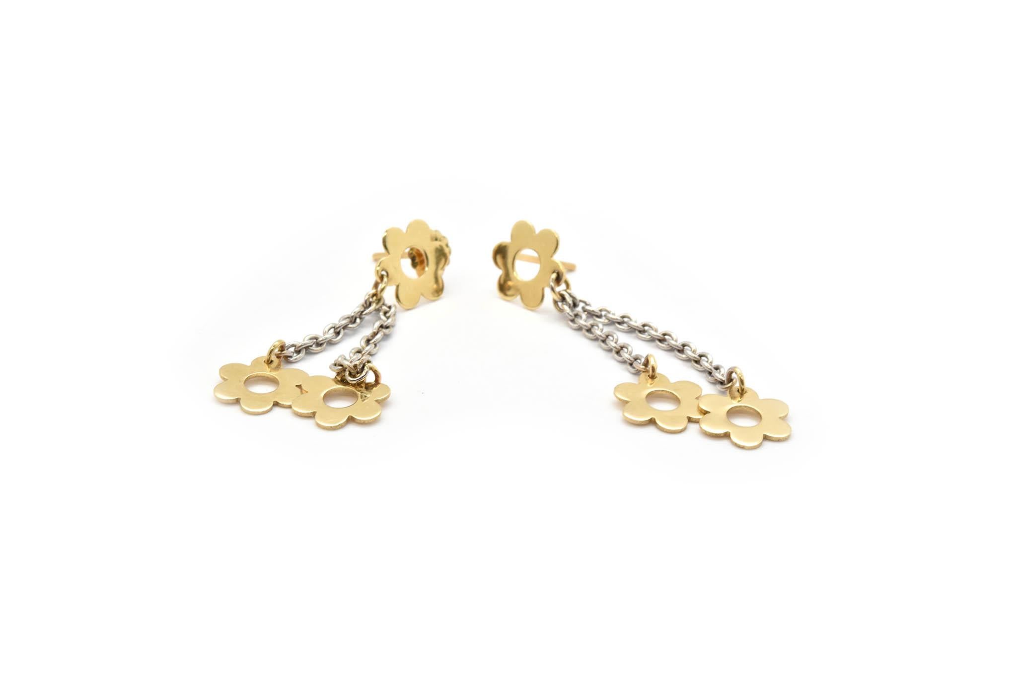 These sweet earrings are designed in 14k yellow gold, yellow gold flower accents are dangling from a chain to make these earrings complete. These earrings dangle about 1 and a half inch from the yellow gold accent that holds the post. These earrings