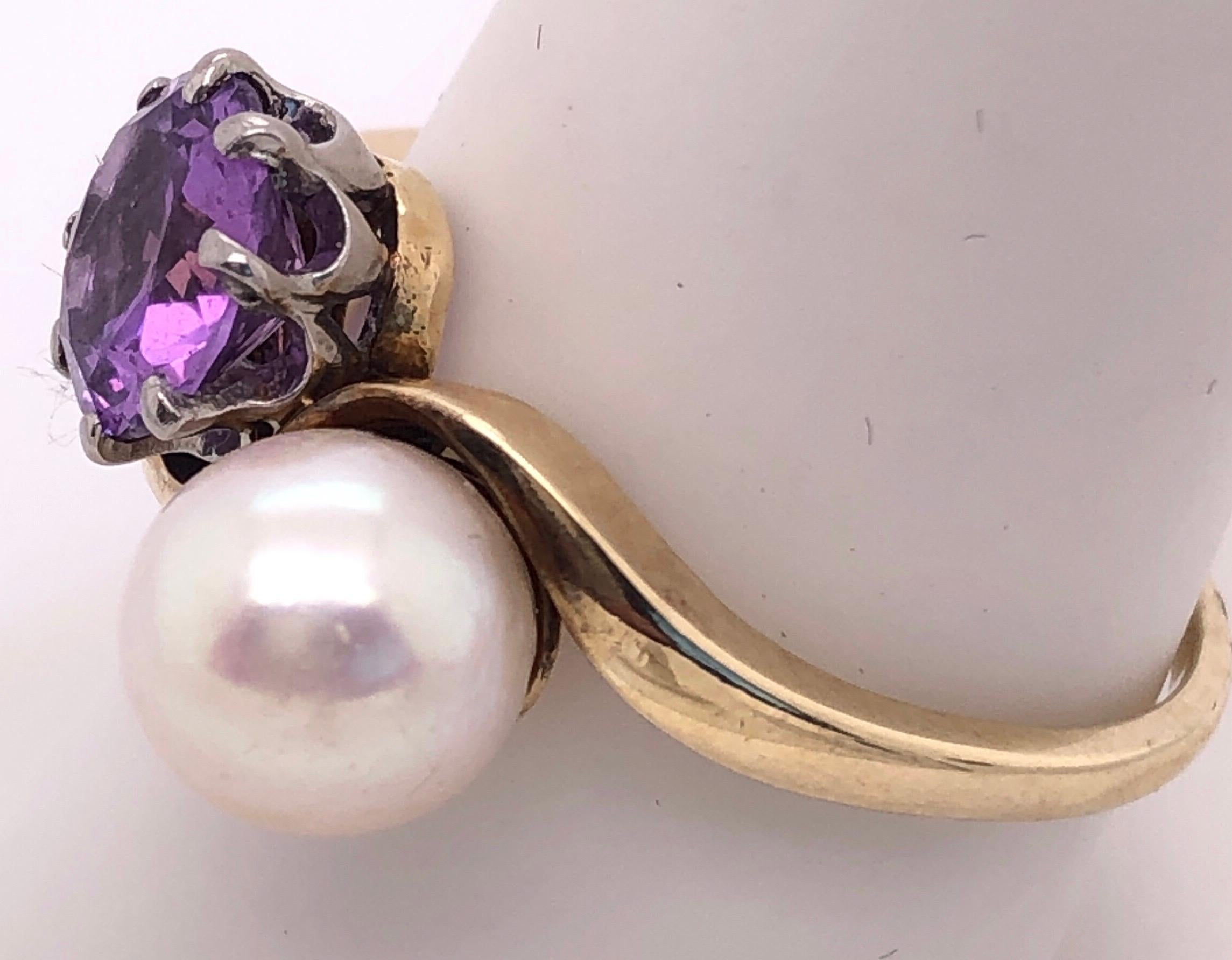 14 Karat Yellow Gold Free Form Ring with Solitaire Amethyst and Pearl  Size 9.5.
Round amethyst and cultured pearl 6.00 mm diameter.
The amethyst is set with white gold prongs.
5 grams total weight.