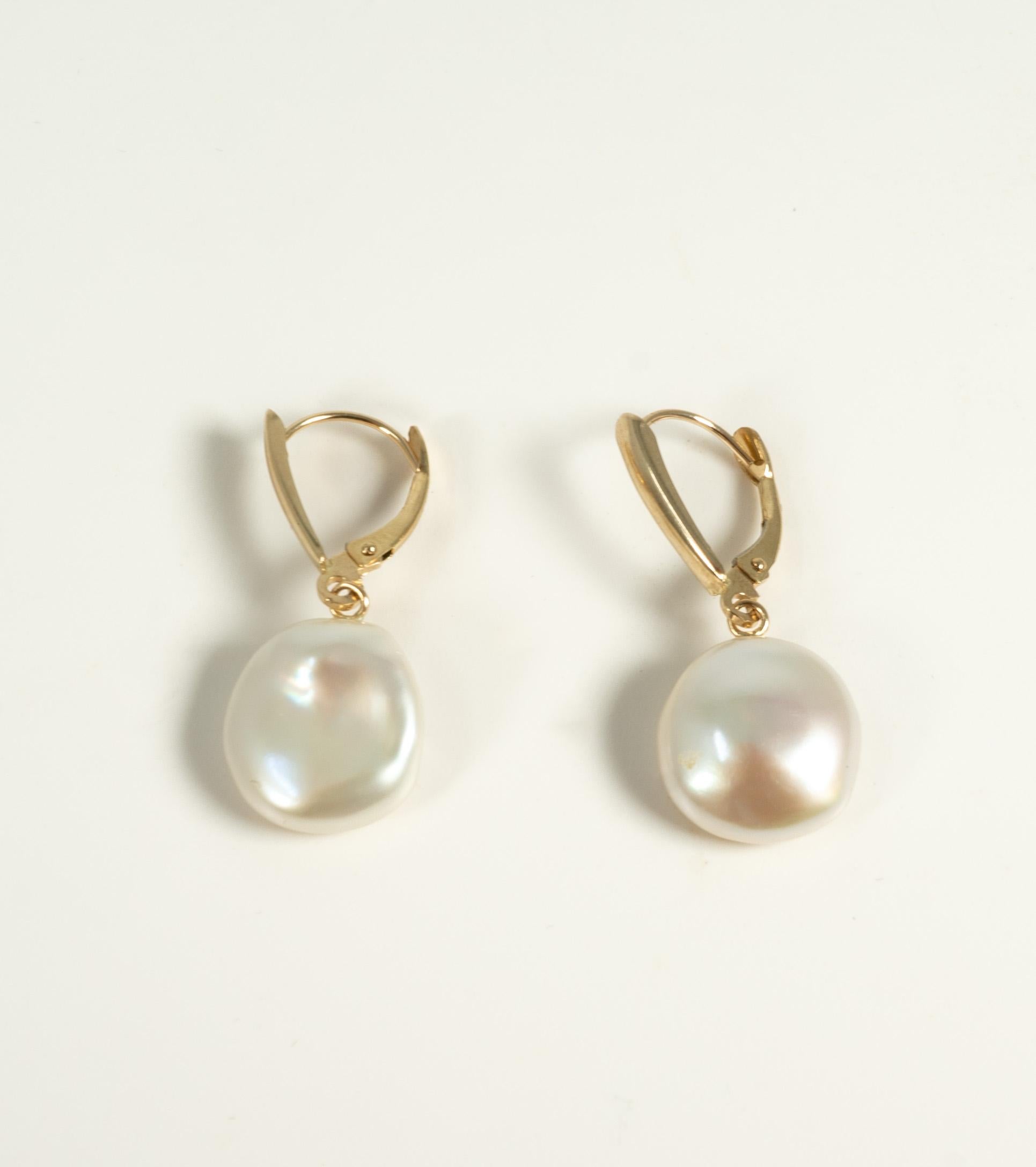 Manufactured by Honora, these 14 karat yellow gold earrings are secured with a lever back and suspend freshwater coin pearls.