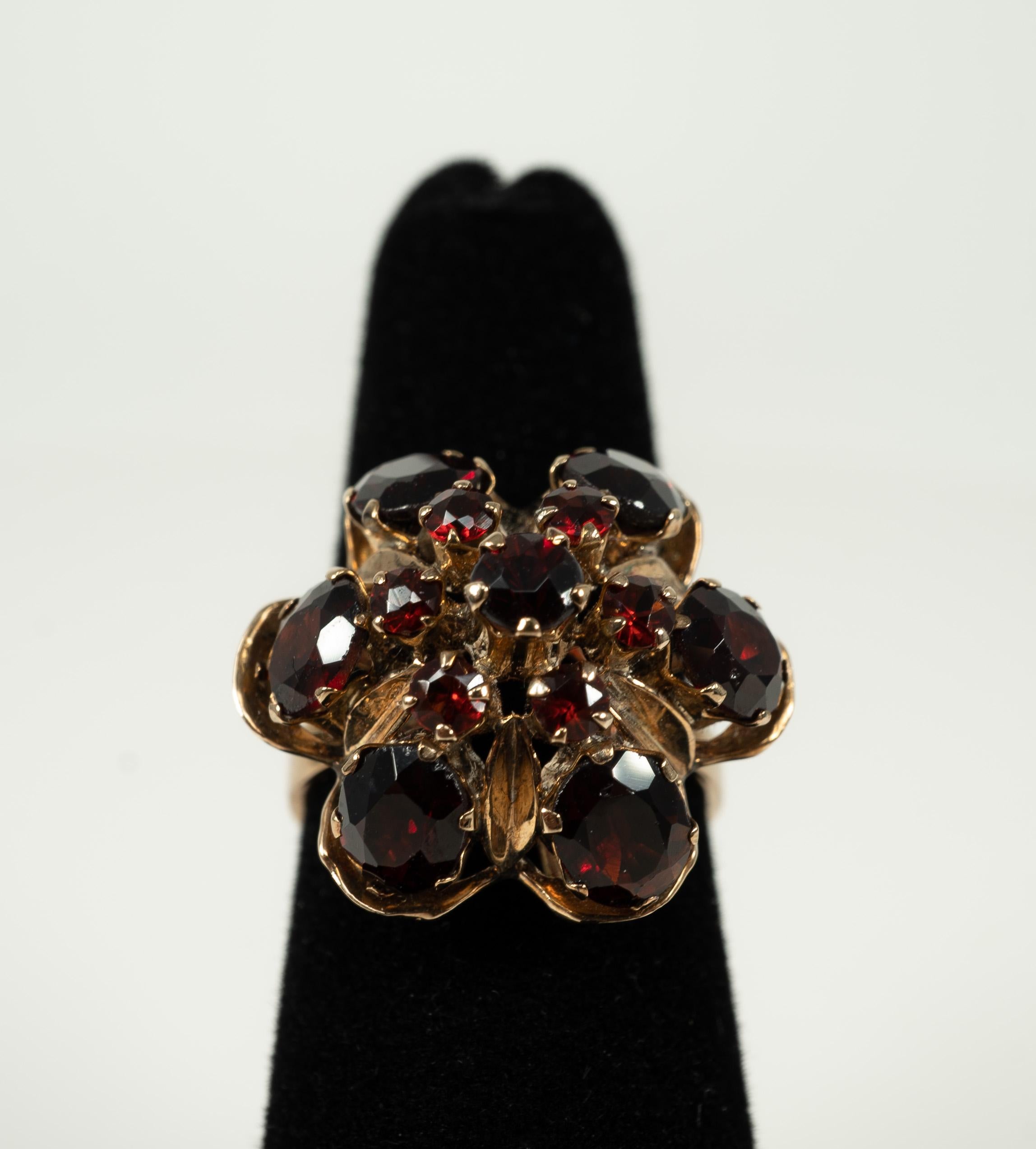 This fun harem ring is in 14 karat yellow gold and supports lovely garnets!