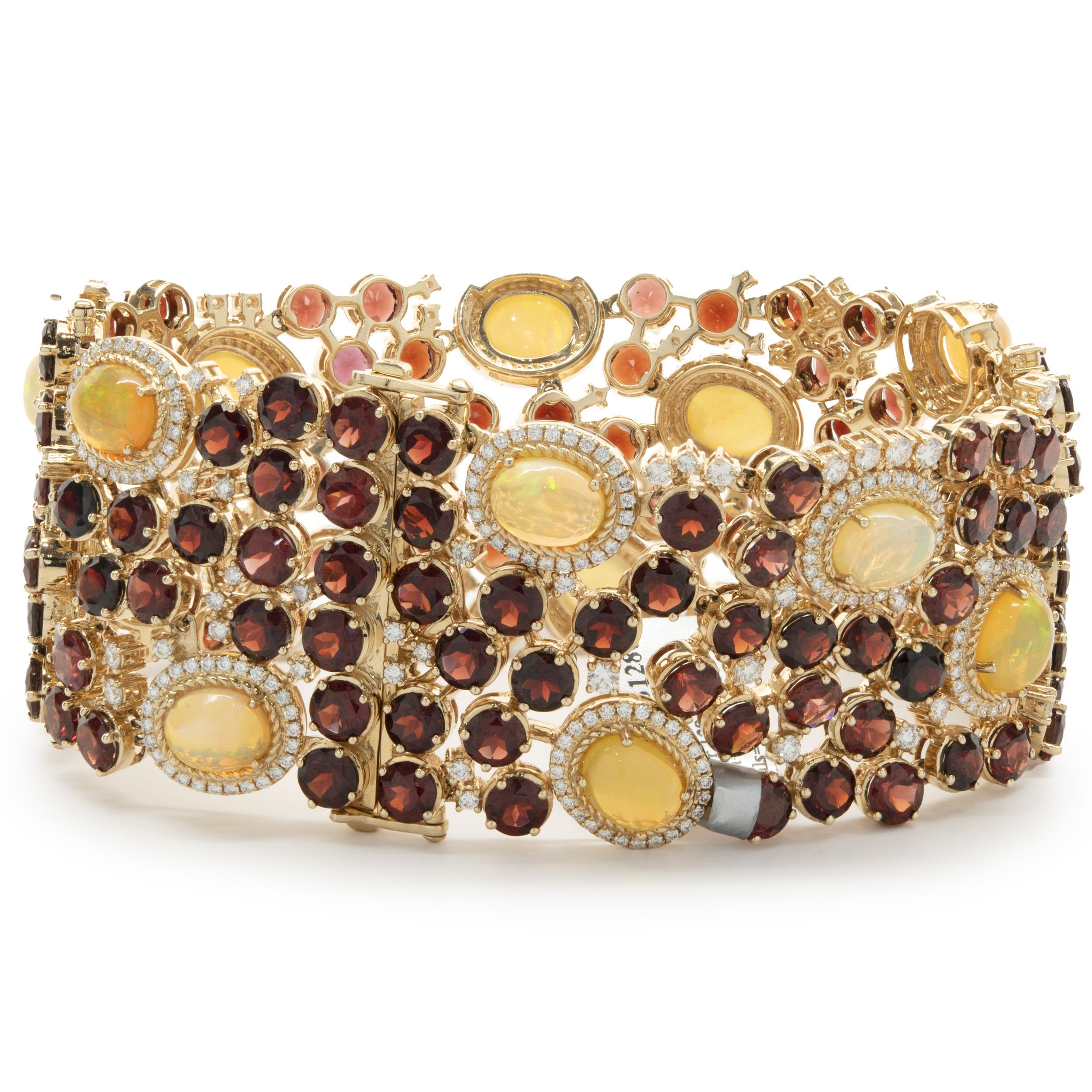 Designer: custom
Material: 14K yellow gold
Garnet: 129 round cut = 75.51cttw
Opal: 14 cabochon cut = 17.17cttw
Weight: 111.42 grams
Dimensions: bracelet measures 7-inches in length, 1.5-inch extender
