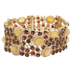 14 Karat Yellow Gold Garnet, Opal, and Diamond Ornate Wide Bracelet