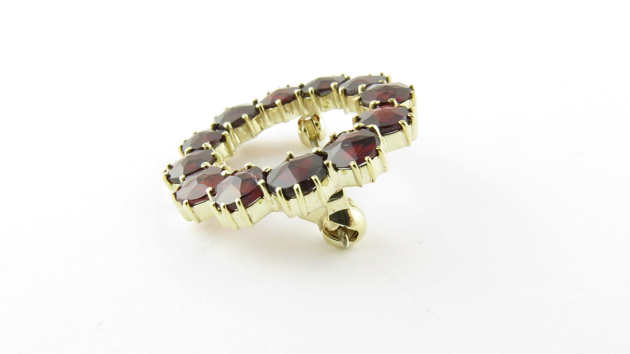 Vintage 14 Karat Yellow Gold Garnet Brooch/Pin- This lovely circle pin features 12 round garnets (5 mm each) set in classic 14K gold. Size: 24 mm Weight: 2.1 dwt. / 3.4 gr. Acid tested for 14K gold. Very good condition, professionally polished.